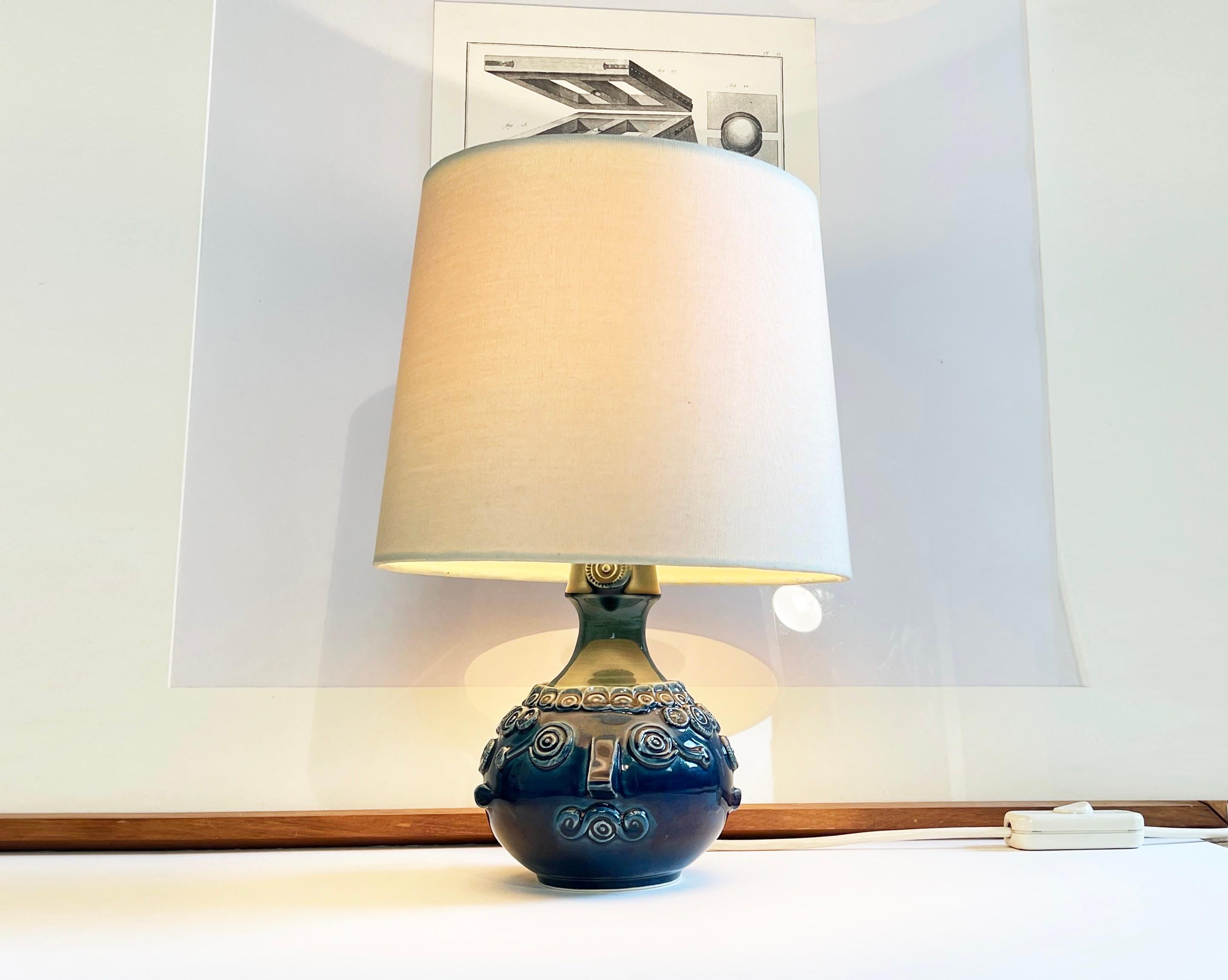 Ausdrucksstarke skandinavische Kunstleuchte von Bjørn Wiinblad für Rosenthals 'Studio Line' Kollektion.
Der Sockel ist aus Keramik mit einer blauen Glasur, die nach oben hin grünlich schimmert.
Das Design ist einfach wunderschön in Form eines Kopfes
