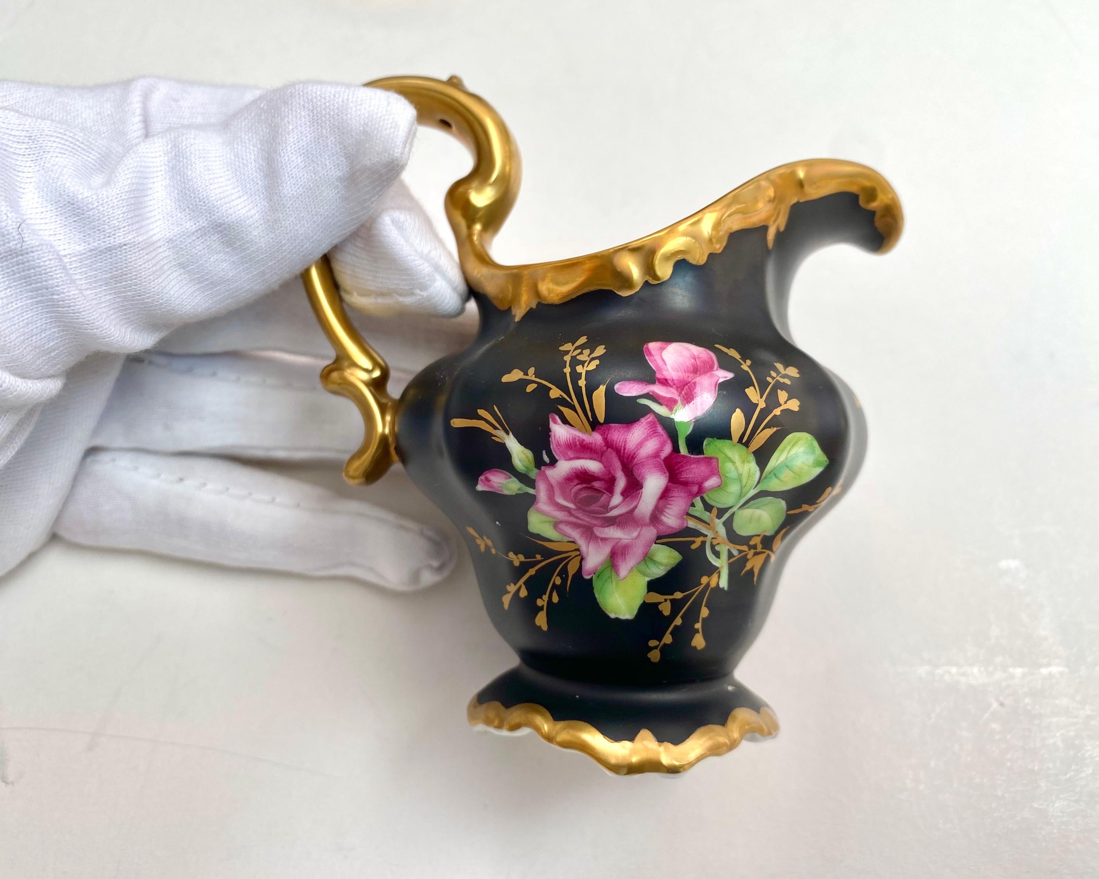 Vintage porcelain coffee set for 2 persons, Tet-A-Tet, 9 items. Pink roses on black background. Gilding. 

From the famous manufactory Rosenthal Selb Germany, 1950s.

In addition to cups and saucers, the set includes a sugar bowl, a teapot and a