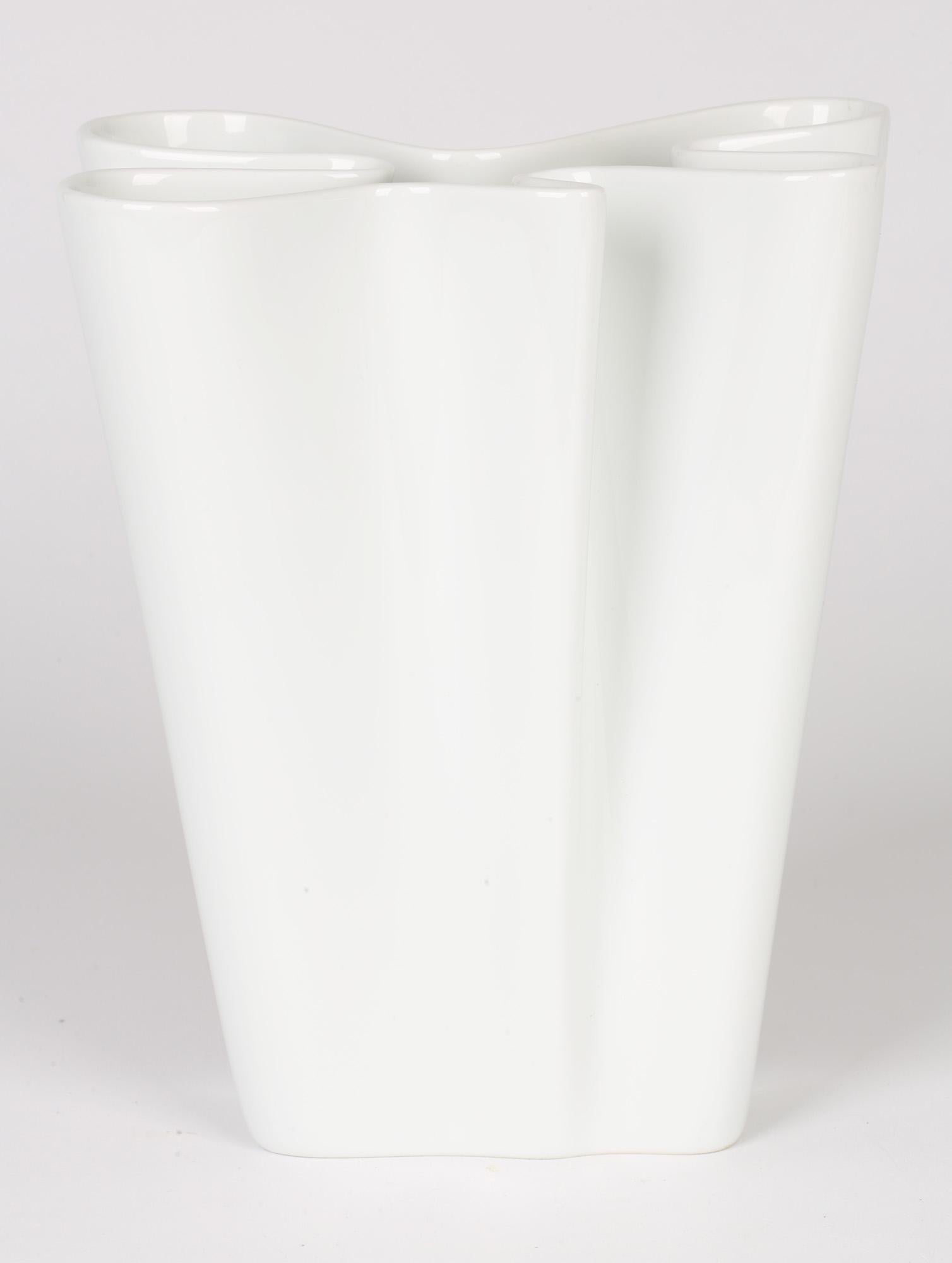 A stylish German porcelain folded paper style vase from the Studio-Line Flux range by Rosenthal and dating from the latter 20th century. The vase stands on an irregular rectangular shaped base and the body is constructed from a series of folded and