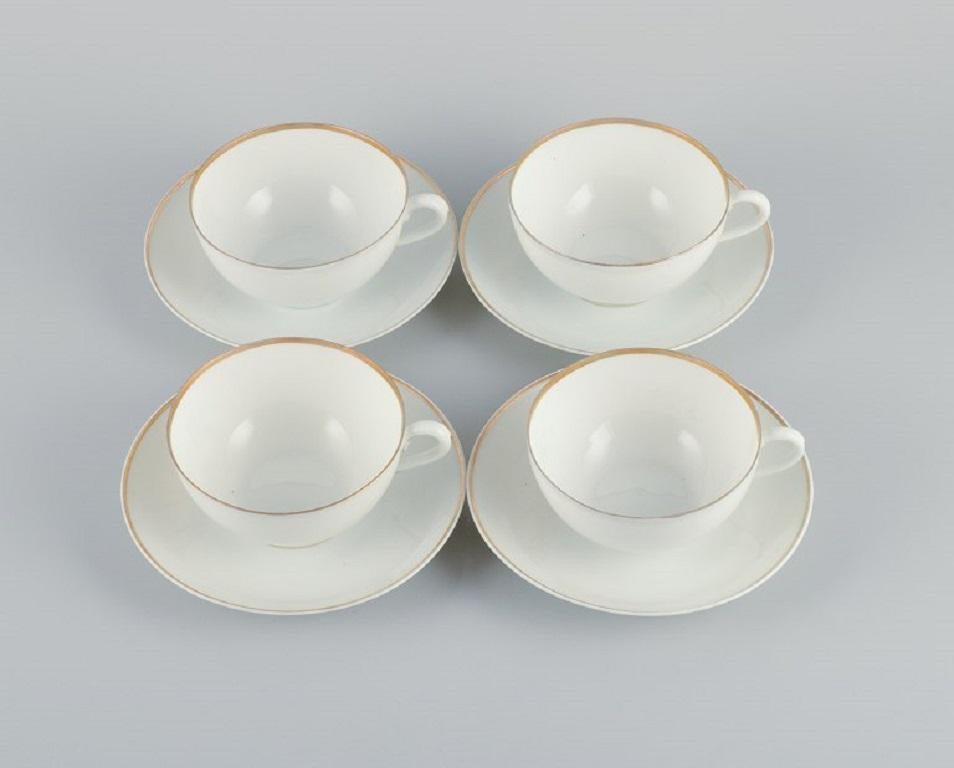 Rosenthal, Germany, a set of four large teacups and matching porcelain saucers. Thin white porcelain with gold decoration.
1903.
In excellent condition with no wear.
All cups with monogram 