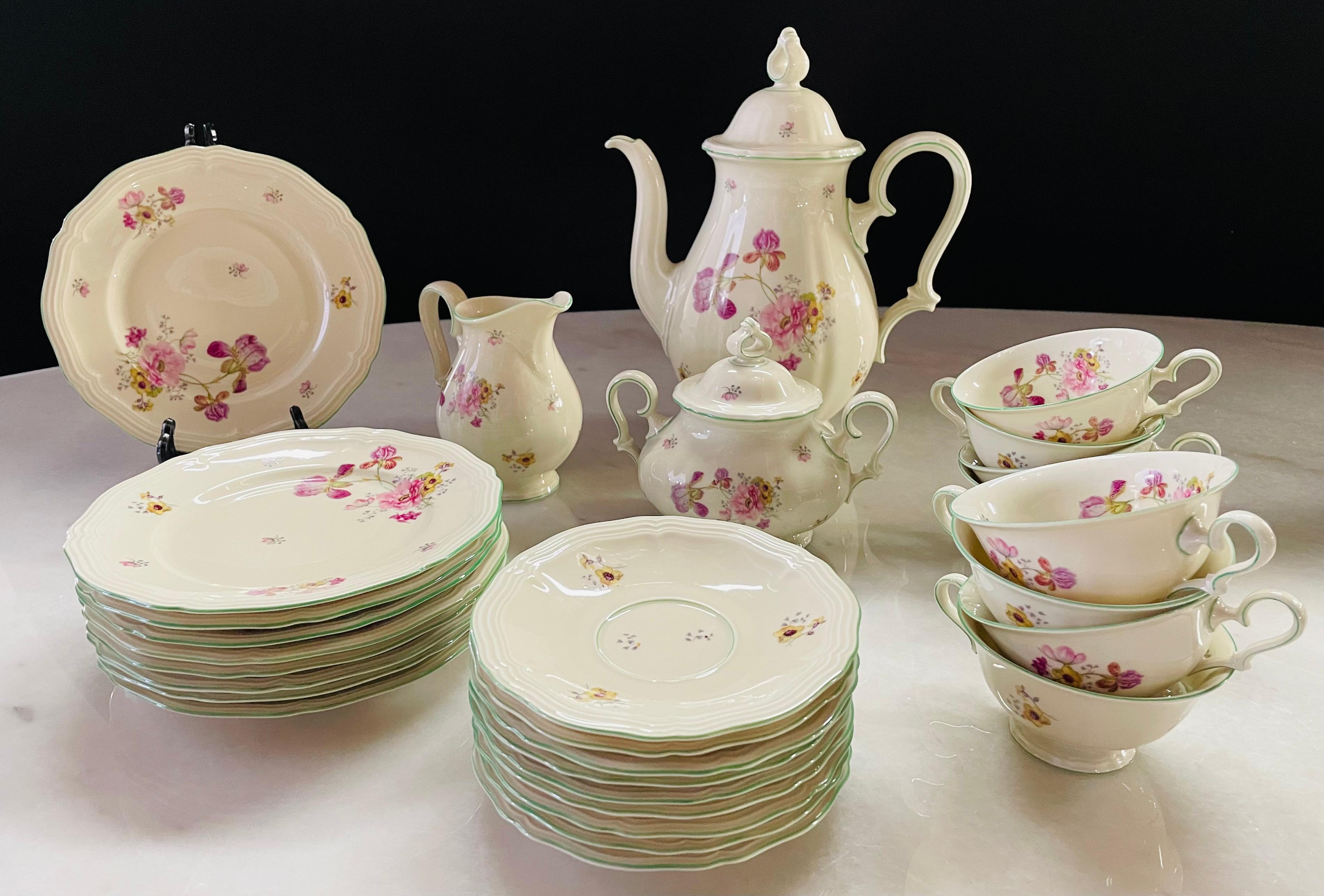 A charming antique Rosenthal coffee or tea set of 29 pieces made in Bahnof Selb, Germany circa 1930's. Each piece features floral decor on white porcelain believed to be inspired by the walls in Sanssouci, the summer palace of Frederick the Great,