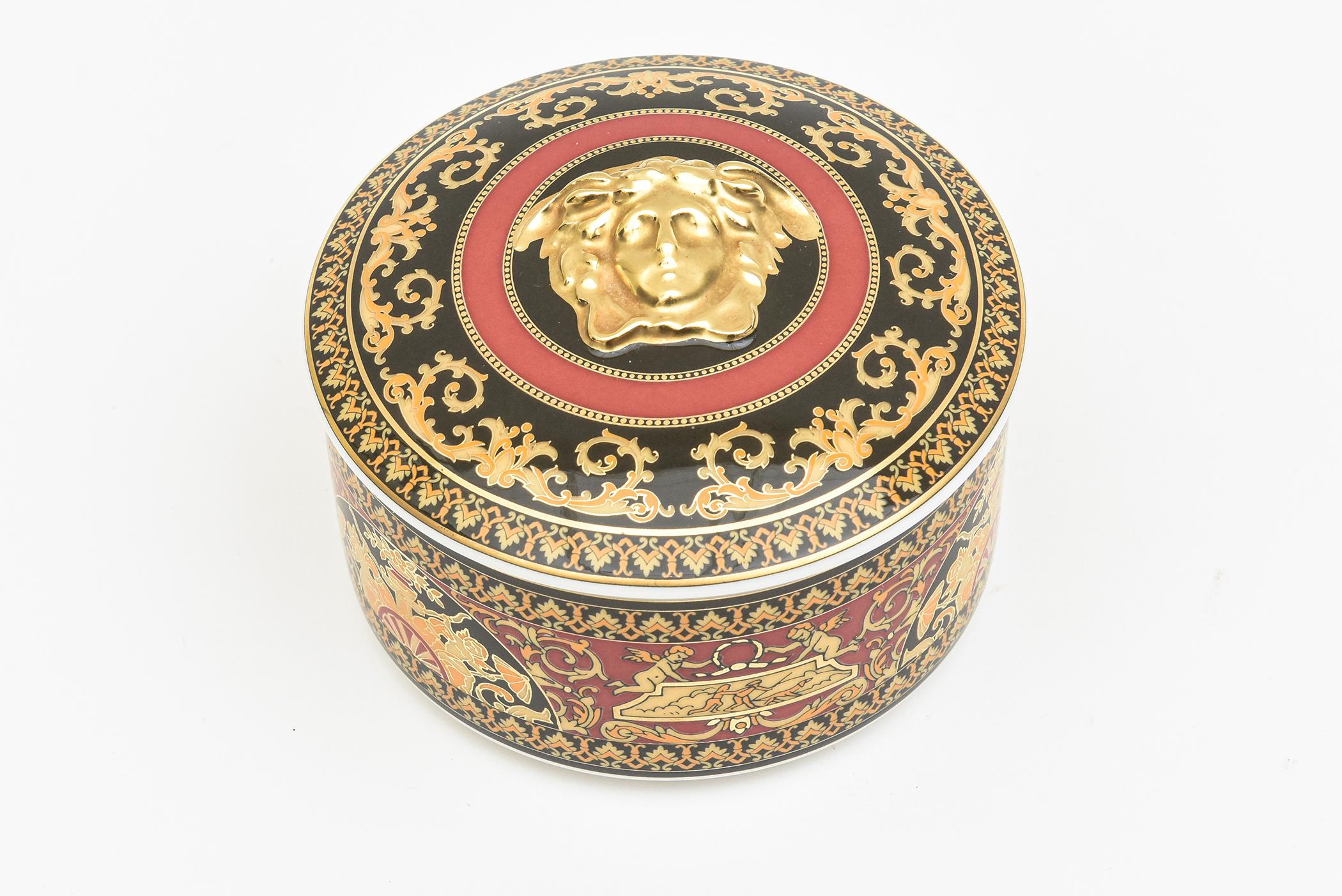 This lovely Rosenthal Studio LIne Germany porcelain 2 part round box was designed by the Versace Home Collection and has the fabulous Medusa head and from the Medusa collection. It is raised on the top of gold plate. The inside of the box is the
