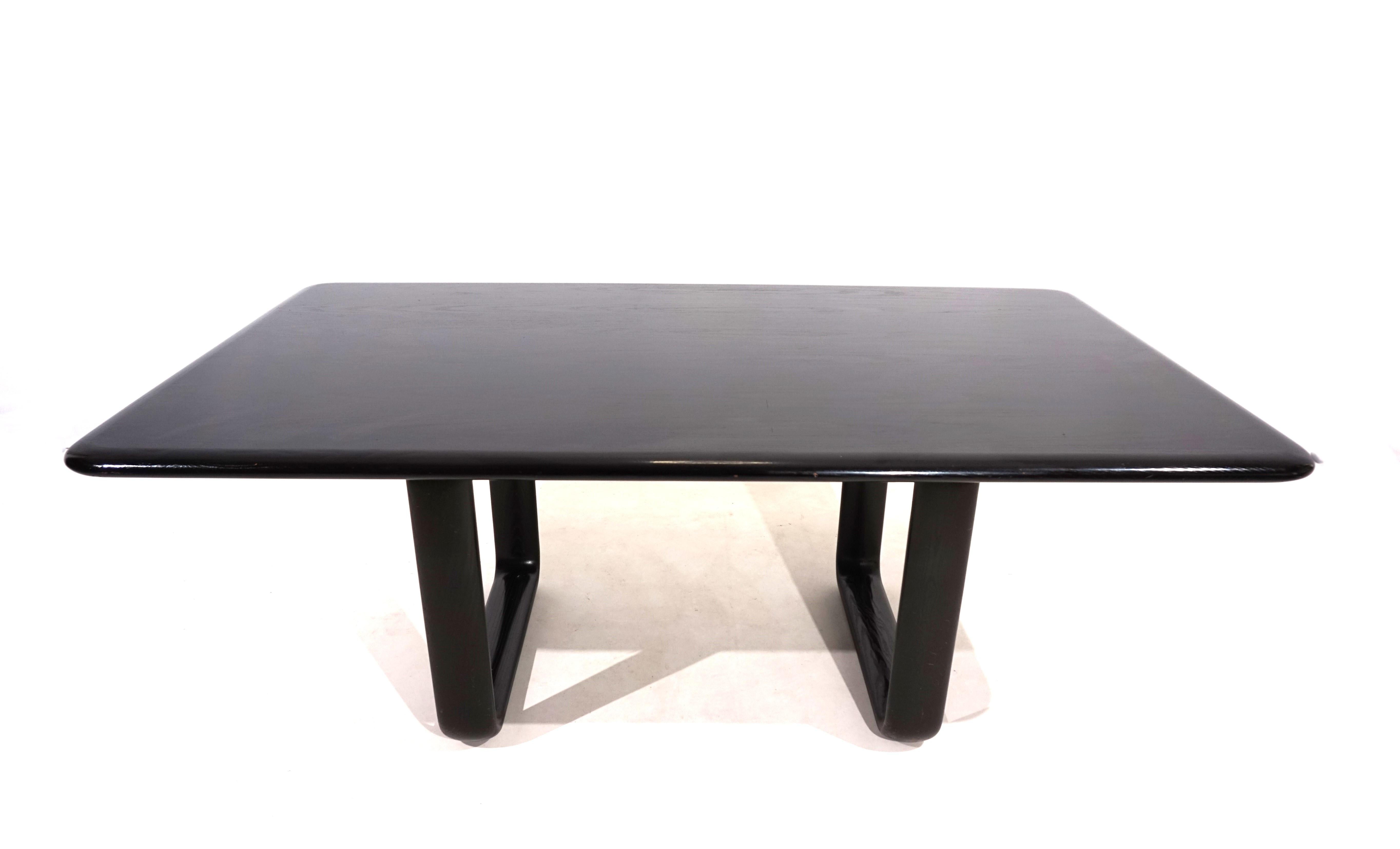 Solid black dining table from Rosenthal in very good condition. The solid wooden table top rests on the cubic wooden arches typical of Hombre and the recessed arrangement of the frame allows for excellent seating at the entire table. The dining