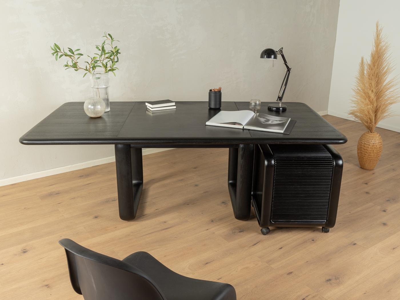 Hombre desk with trolley by Burkhard Vogtherr for Rosenthal from the 1970s. High-quality solid frame and veneered table top in black stained ash with a leather writing surface, a compartment for writing utensils and solid wood edges. Trolley