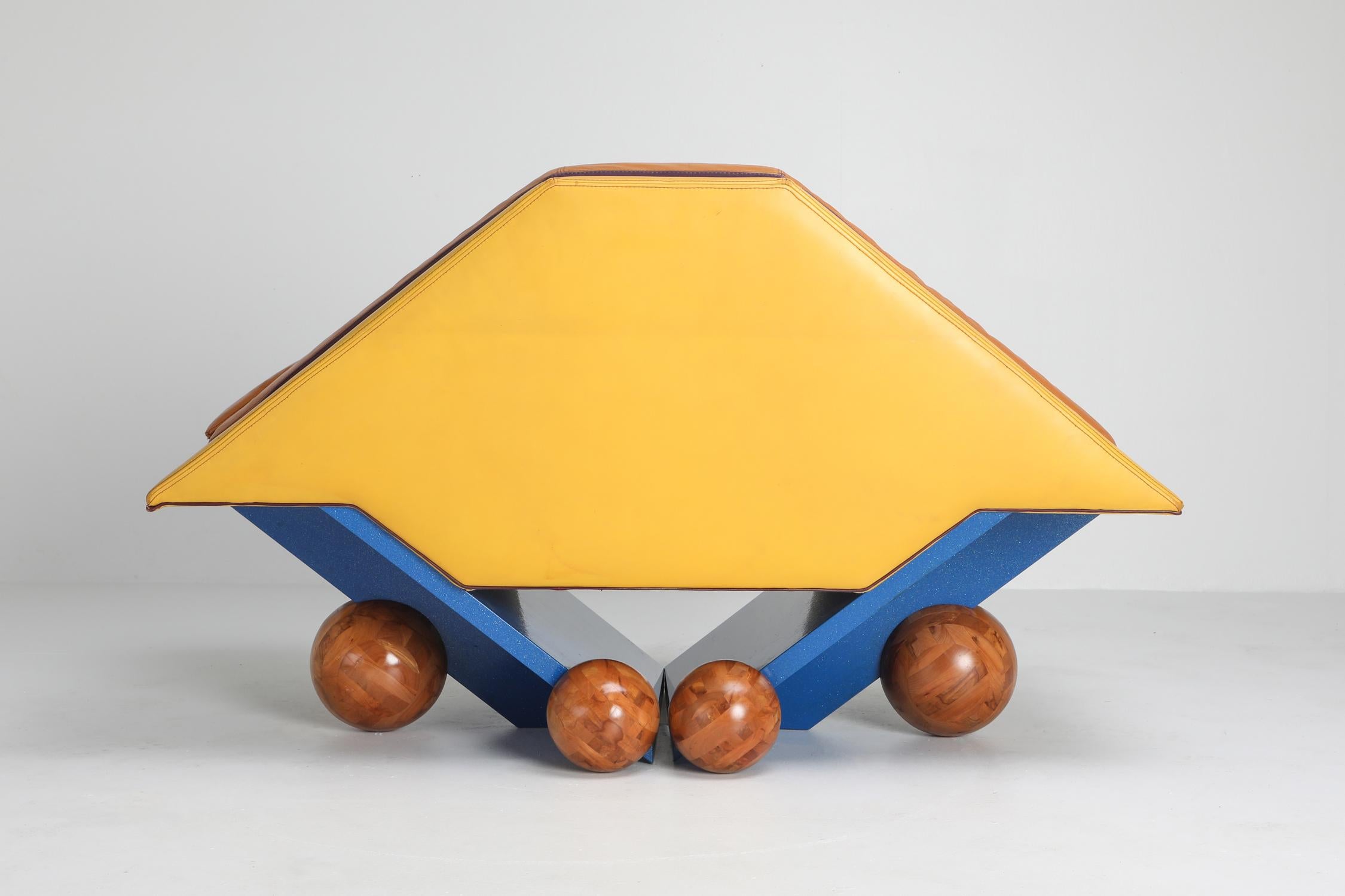 Postmodern diamond-shaped leather chair, Rosenthal, Germany, 1980s

Unusual club chair in a variety of colors.
Leather seating, wooden frame, and wooden spherical balls serve as feet.
Memphis style piece typical from the 1980s.