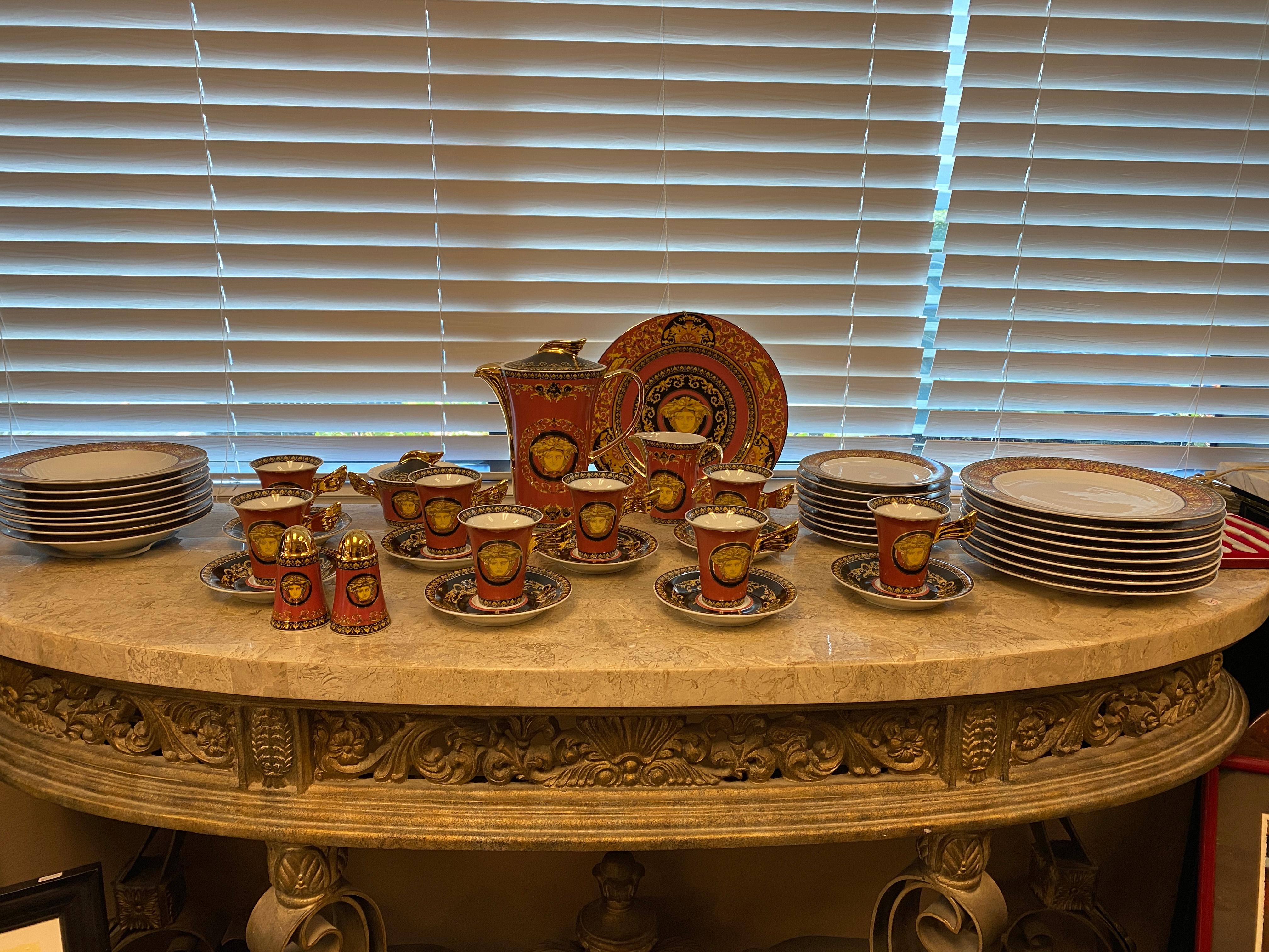 Rosenthal Metts Versace Red Dinnerware Set of 44 pieces 
8 cups with 8 saucers
1 Medusa Red Service Plate
8 Soup Plates/Bowls
8 Dinner Plates
8 Desert Plates
2 Salt/Papper 
1 Coffee Pot
1 Bowl for Sugar
1 Creamer