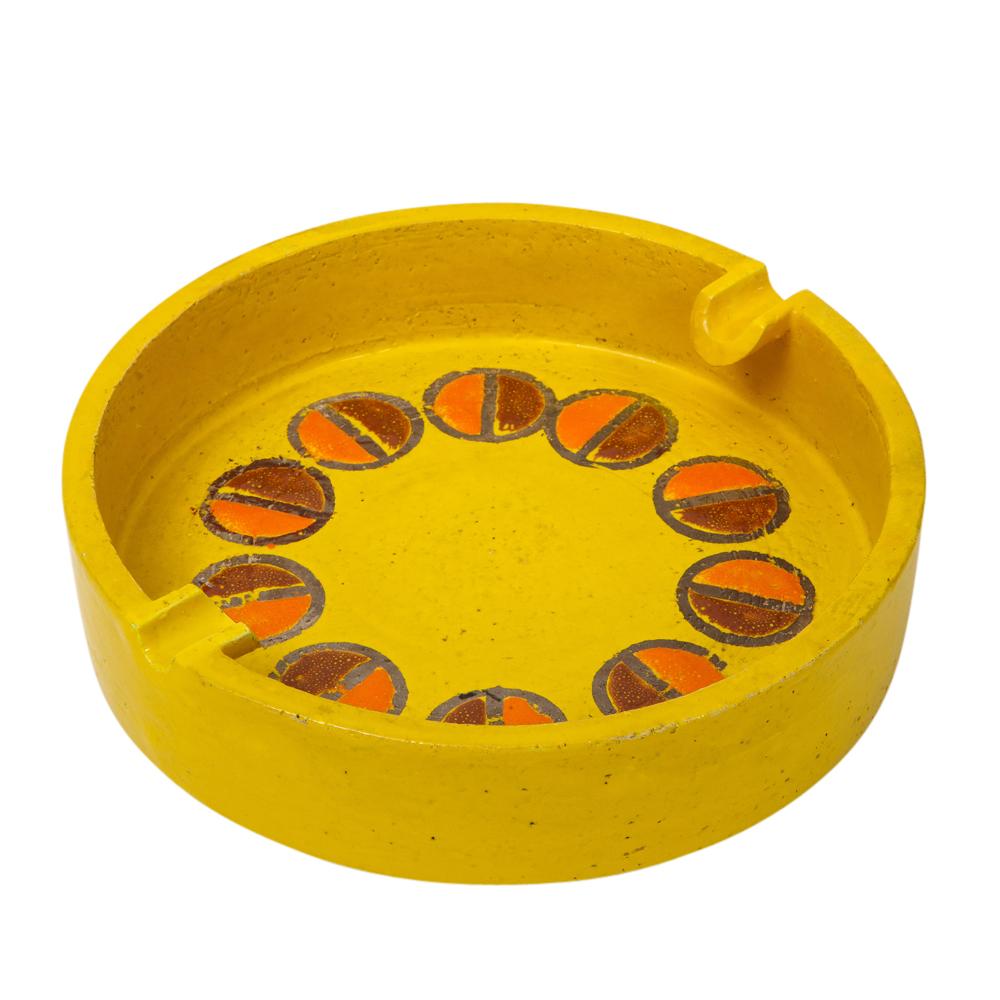 Rosenthal Netter ashtray, ceramic, yellow and orange, discs, signed. Medium scale yellow glazed ashtray decorated with two rows of half circles, in dark and lighter shades of orange. Two trays for cigarettes. Signed with Rosenthal Netter label on