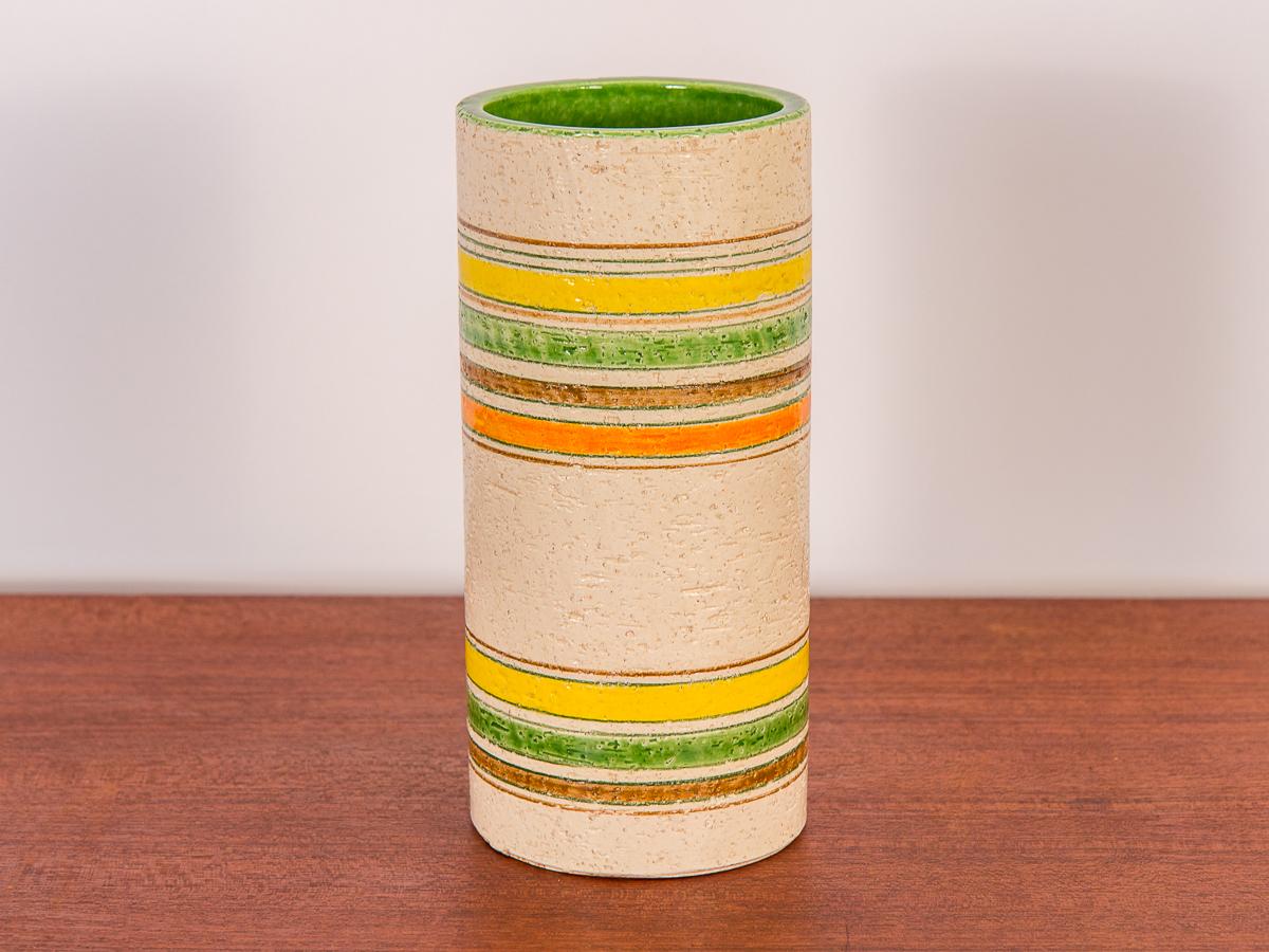 Midcentury Italian art pottery vase by Rosenthal Netter for Bitossi. Pretty cylindrical vase with a textural spring palette. Vase has a bright green interior, and striped orange, brown, yellow, and green stripes on the outside against a mottled