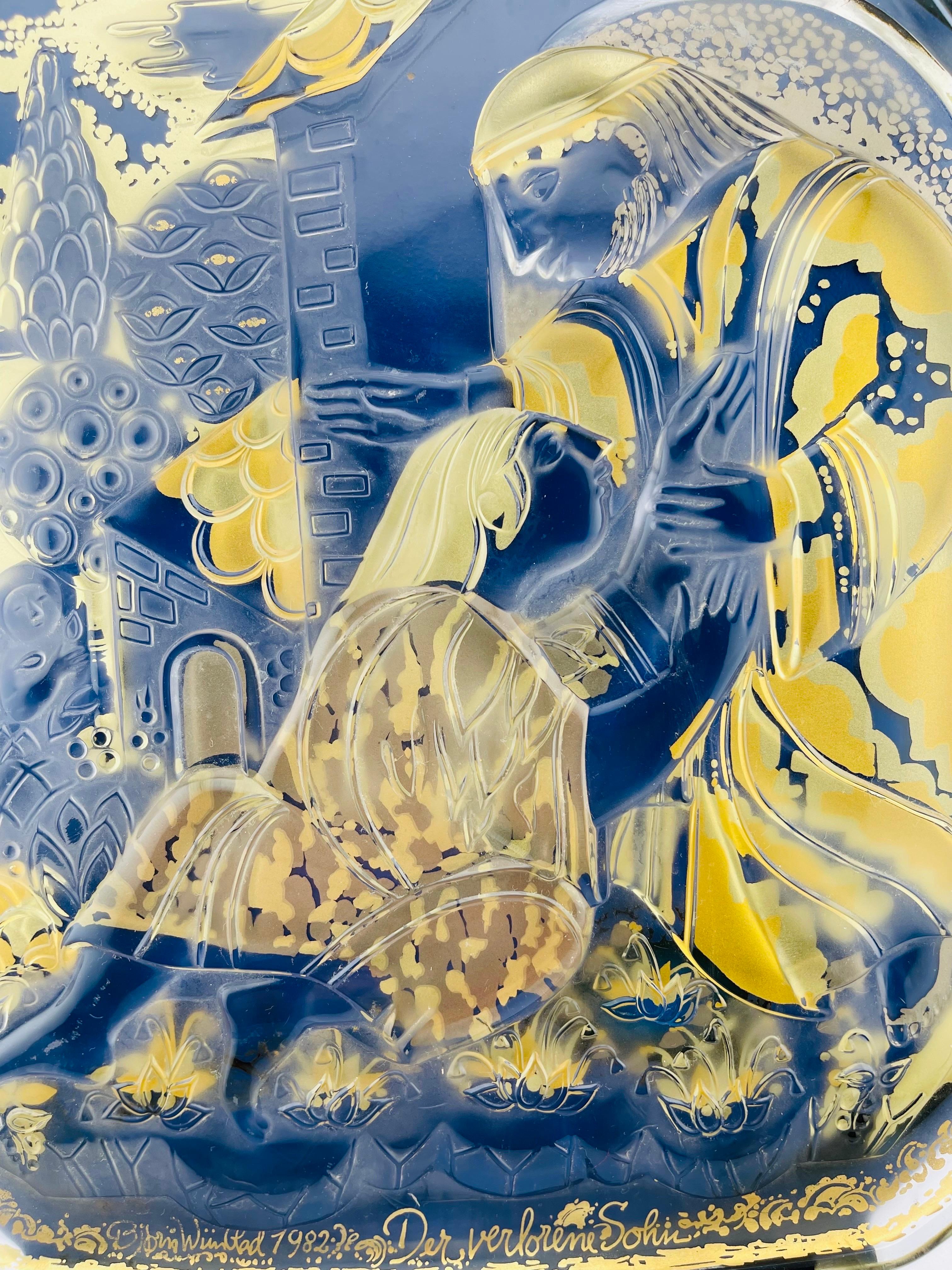 Wall plate by the Danish designer Bjørn Wiinblad for Rosenthal made of metal wall mounted sheet lacquered in black and gilt with glass faceted frosted Art Glass.Limited edition from 1982 from the series 'Gleichnis im Glas' Title of the wall plate is