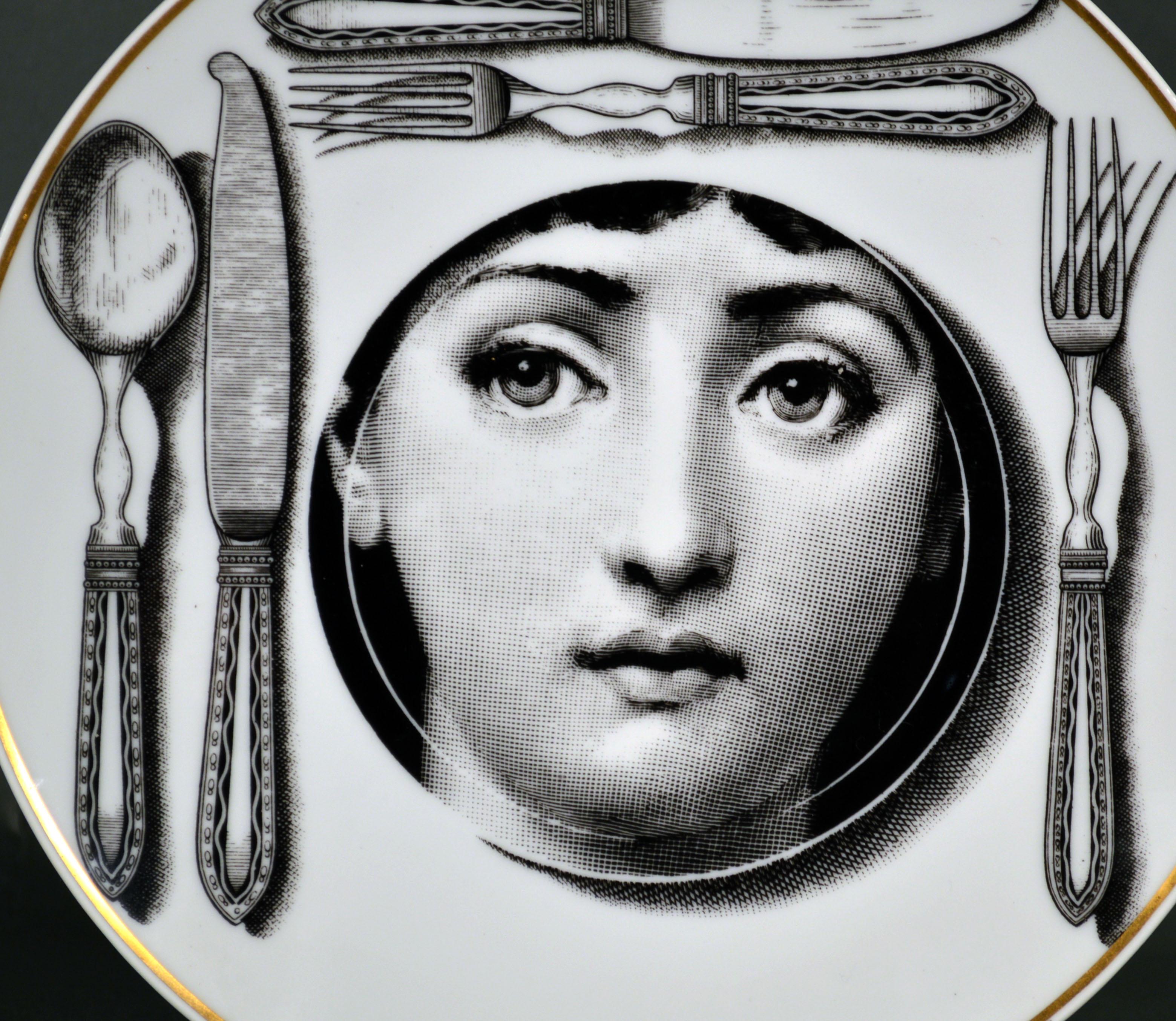 Rosenthal Piero Fornasetti porcelain plate,
Themes & Variation pattern, Motiv 11,
1980s

The striking Rosenthal Fornasetti gold-rimmed black and white printed plate with the face of Lina Cavalieri depicted a dinner plate with knives and forks on