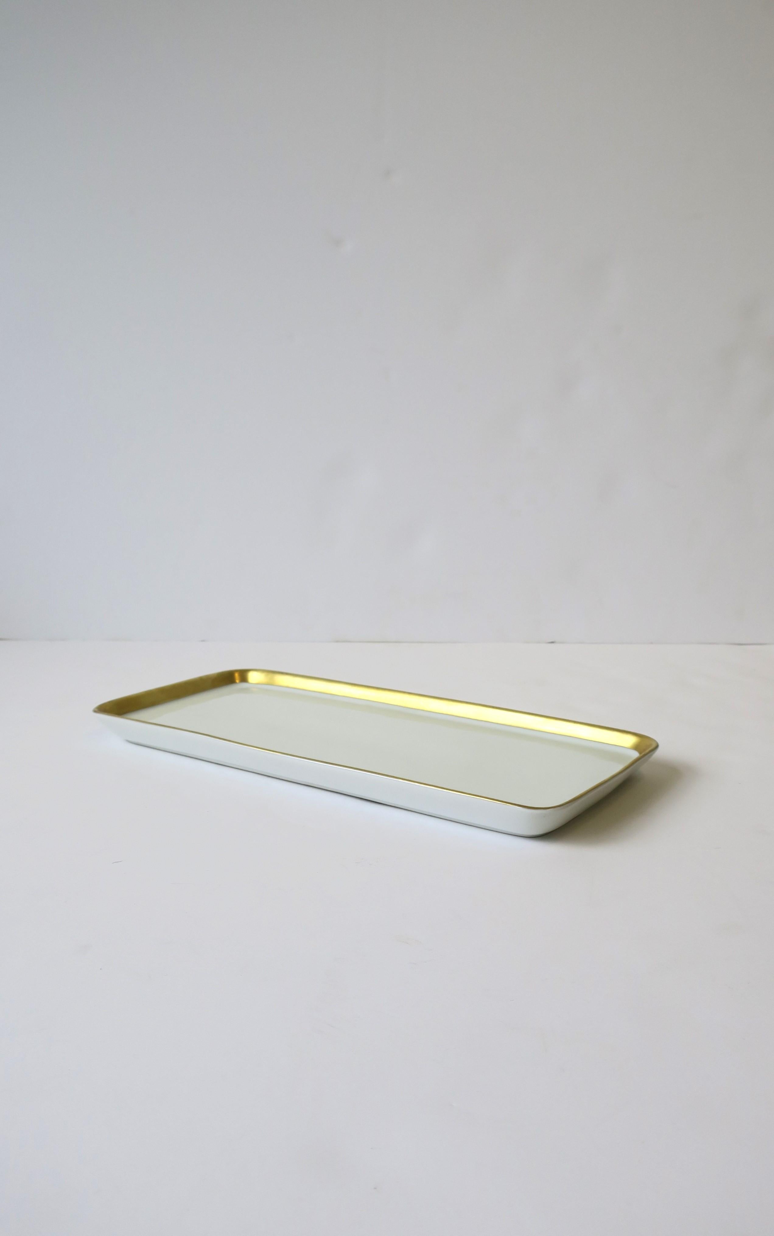 A beautiful German porcelain serving tray in the Kurfurstendamm Berlin pattern, designed by Hans Theo Baumann for Rosenthal, 1959, Germany. Piece is white glazed porcelain with gold band around edge, rectangular in shape. Piece was design as a