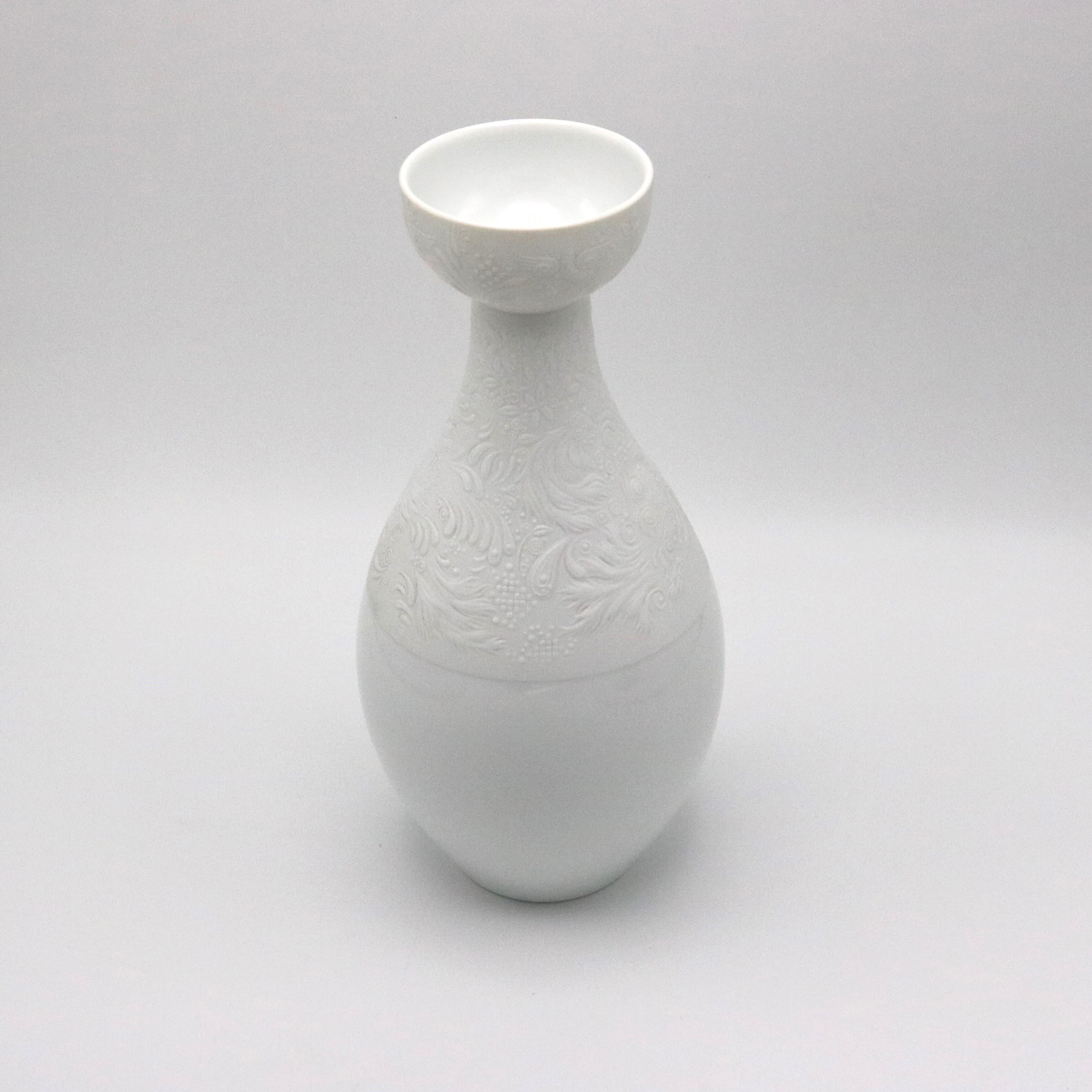 A ceramic vase with the “Magic Flute” motif for the Rosenthal Studio Line designed by Bjorn Wiindblad from Germany circa 1990. The vase features a matte white porcelain with signature and markings underneath.