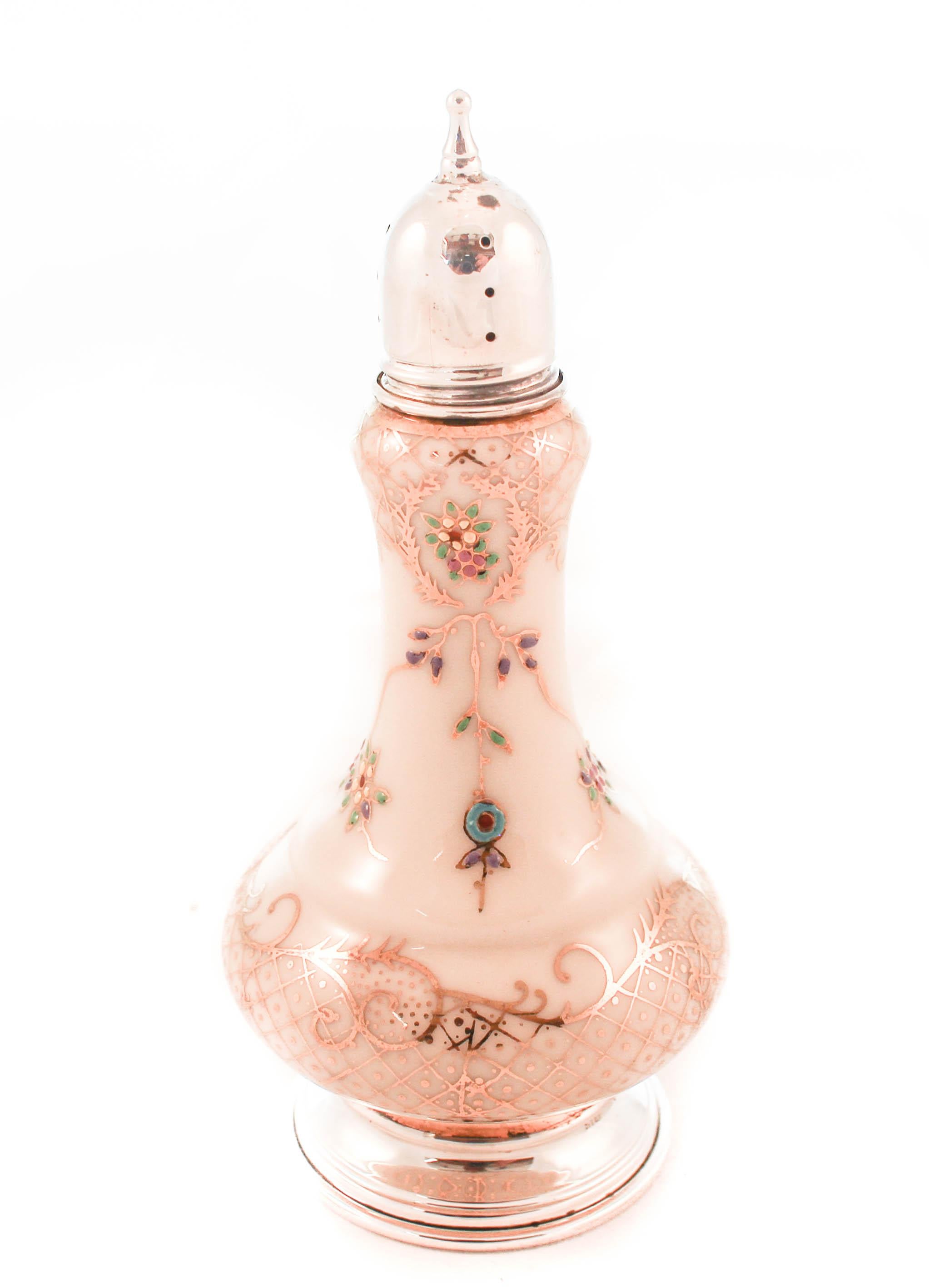 We are proud to offer this pair of sterling silver and porcelain salt and pepper shakers. Made by the world renowned porcelain company, Rosenthal of Bavaria. Hand painted gold leaf swirls and vines cover the body with blue and green flowers add a