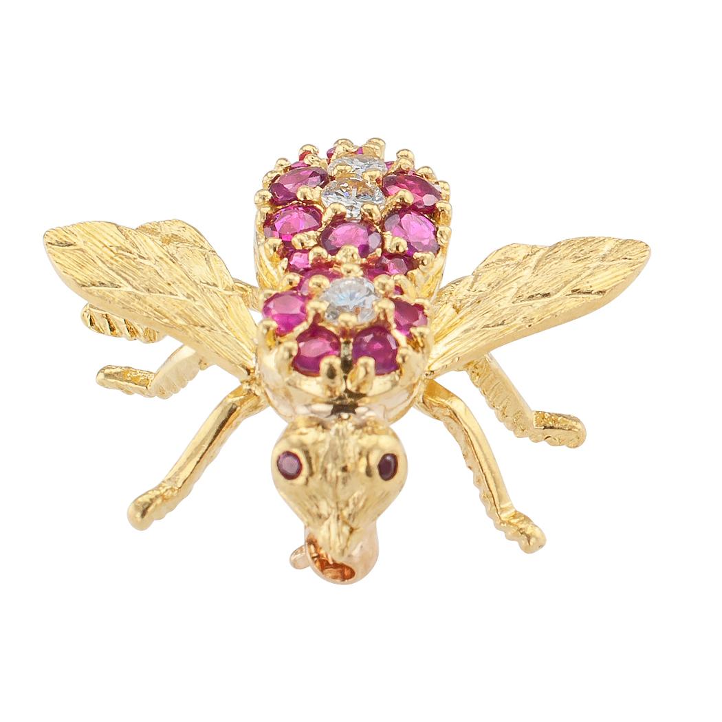 Rosenthal ruby diamond and gold bee brooch circa 1970.

DETAILS:
Rosenthal ruby and diamond bee brooch.
Three round brilliant-cut diamonds totaling approximately 0.20 carat, approximately G – H color and VS clarity.
Eighteen round rubies. 
18-karat
