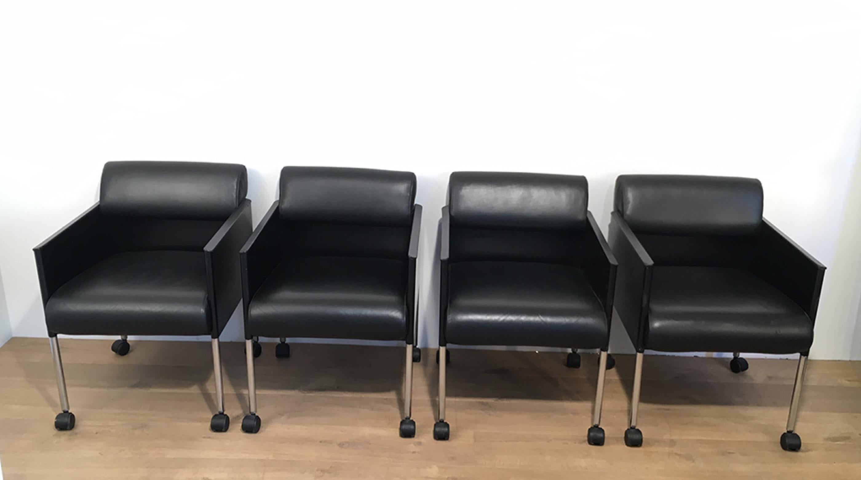 This interesting set of 4 armchairs on casters is signed by Rosenthal. These armchairs are made of black lacquered metal, black molded plastic and leather. These armchairs are very comfortable. They are German, circa 1970.