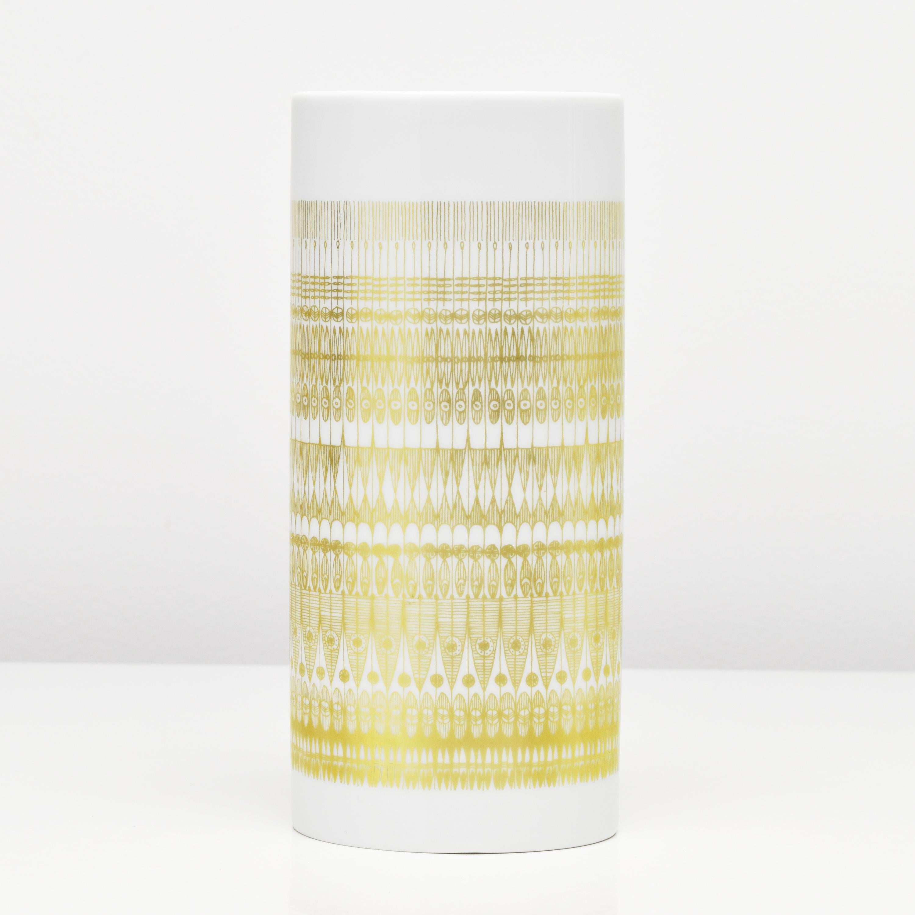 An elegant porcelain vase designed by Hans Theo Baumann for Rosenthal. The vase has an oval shape, with a glossy glaze that creates a smooth and polished surface, while the matte golden decor creates a subtle contrast and highlight the vase's