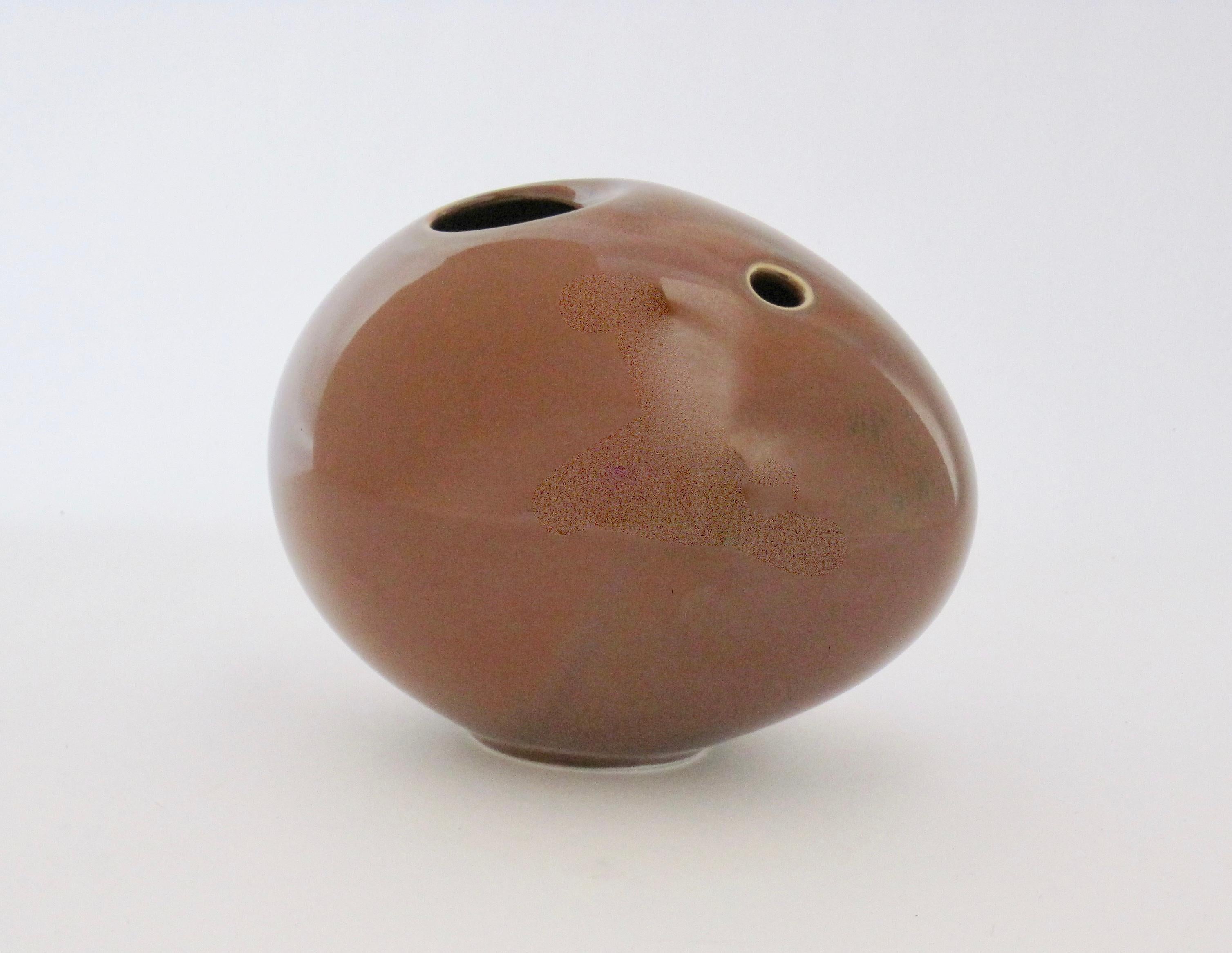 An obscure Rosenthal Studio-linie Germany umber brown egg-shaped bud vase. There are swirls of a deep brown/black and green/gray within the glaze. Interesting piece, I see it with cuttings of cherry blossoms.