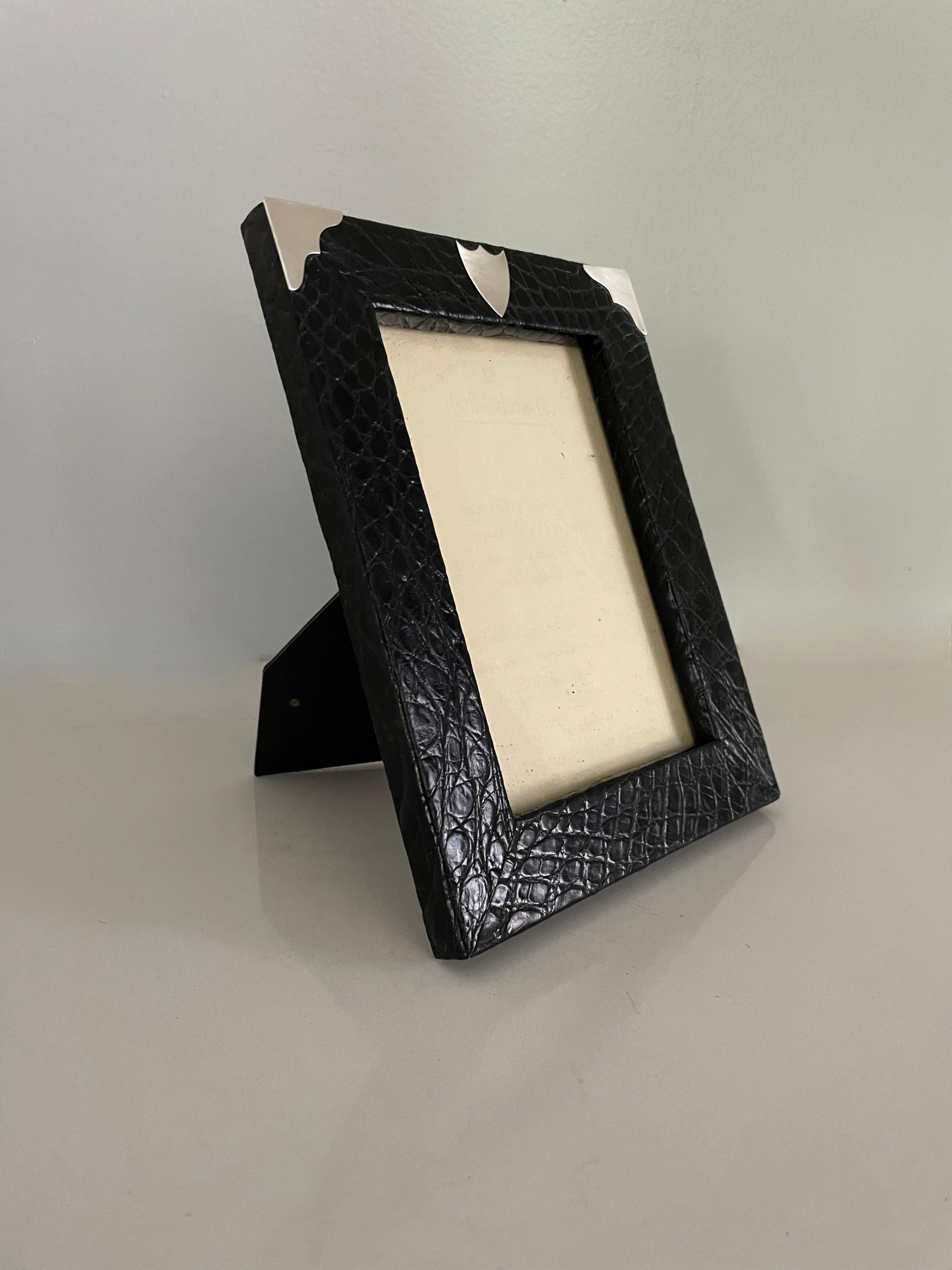 A beautiful English frame made of Alligator and sterling silver corners. A beautiful frame in the style of Ralph Lauren - in very good condition and ready to house a photo of anyone beautifully styled for your bedroom, living room, console table or