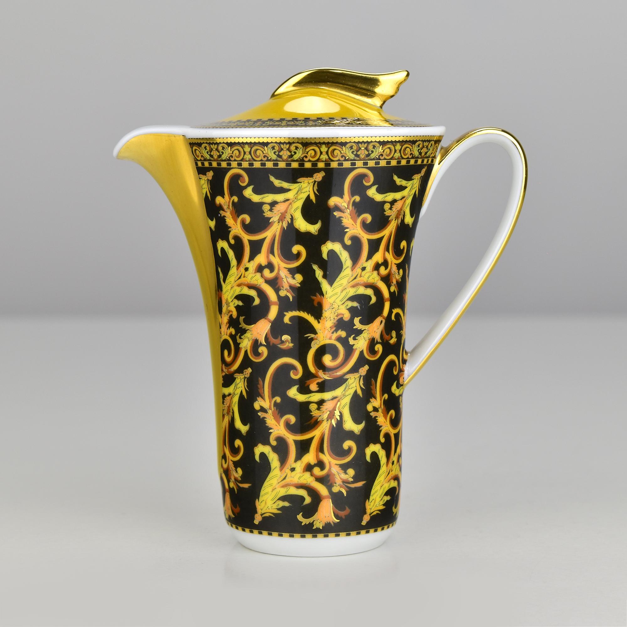 This luxurious Rosenthal Versace “Barocco” creamer (milk jug) showcases the unmistakable opulence of the Versace aesthetic. Designed in collaboration with Rosenthal, the piece is adorned with the iconic Barocco scrollwork in vivid yellows and golds