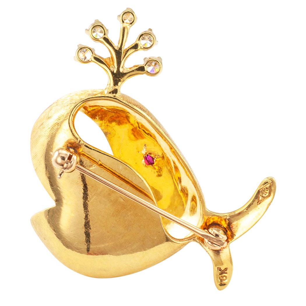 Rosenthal whale brooch in 18 karat gold with diamonds and a ruby eye, circa 1970. The ultra-whimsical design depicts a whale sporting a heart-shaped smile almost as big as all of itself, spouting a shower of diamonds!!! With that big heart-shaped
