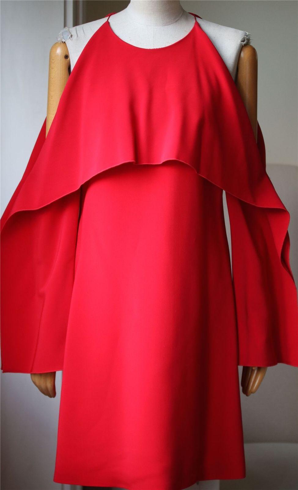 Rosetta Getty's collection is inspired by the iconic felt works of American conceptual artist Robert Morris. Made from stretch-cady, this dress has a draped overlay that folds over the bodice, cutout shoulders and wide, geometric sleeves. Red