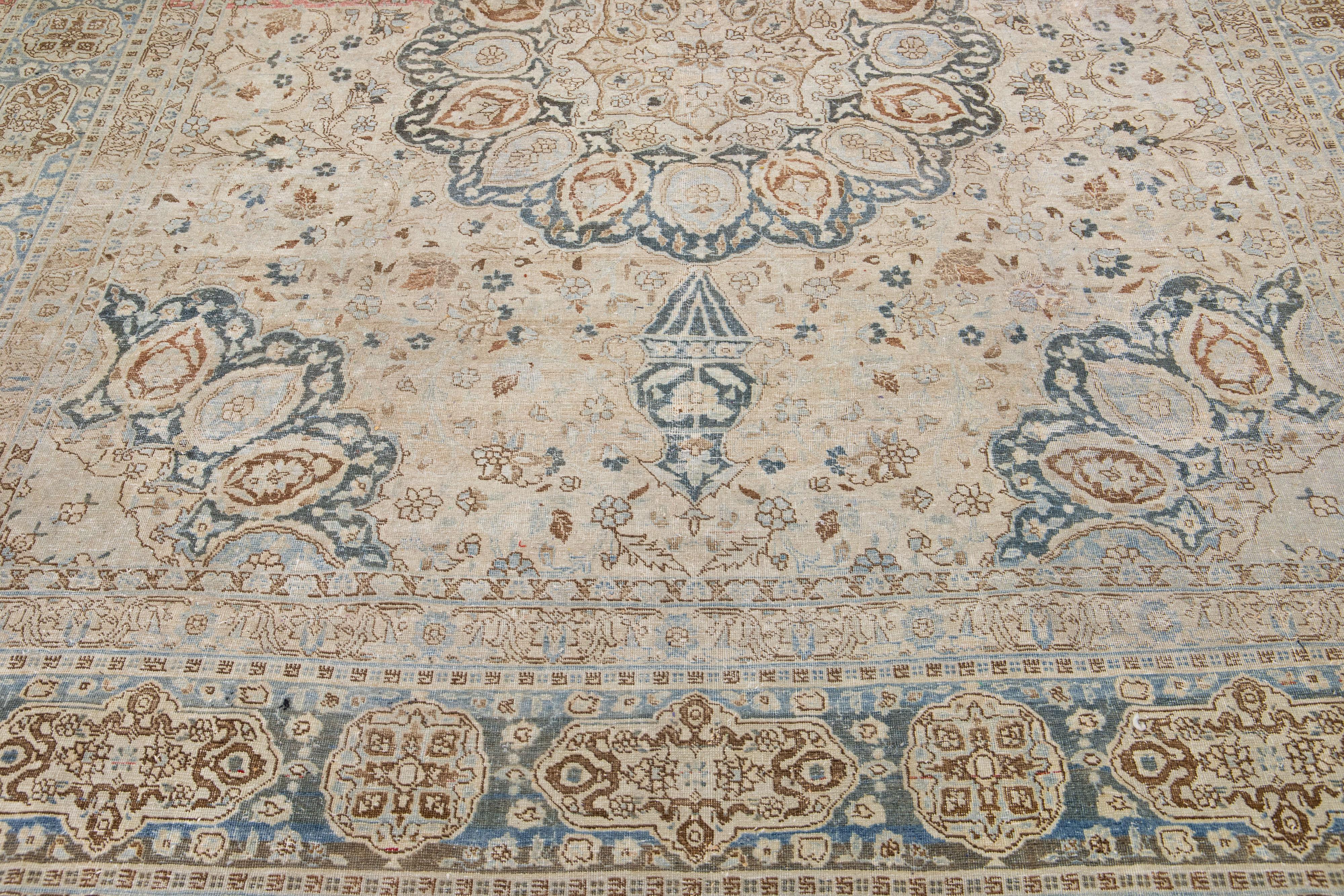 Beautiful antique Persian hand-knotted wool rug with a beige color field. This piece has a blue-designed frame with blue and brown accents in a gorgeous medallion design.

This rug measures: 9' x 11'6