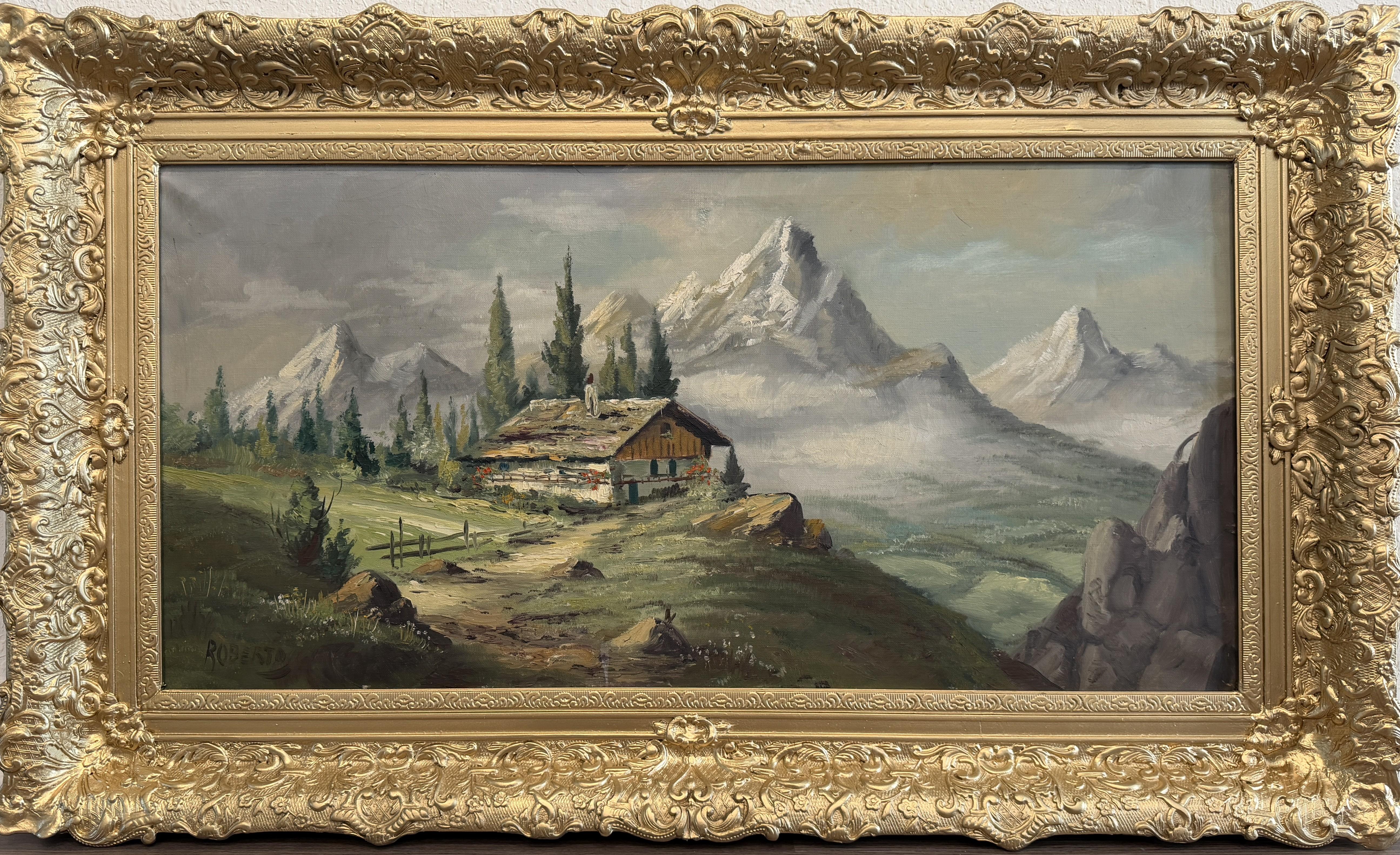 This vintage oil on canvas depicts a serene alpine mountain landscape centered around a rustic chalet perched on a grassy hillside. Tall evergreen trees frame the structure, while a winding path leads the viewer’s eye toward mist-covered valleys and