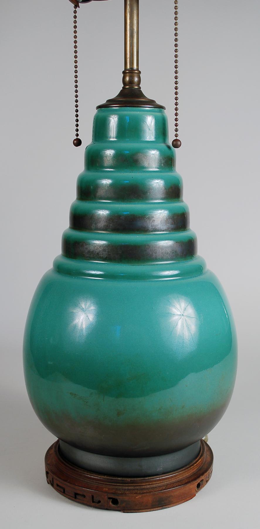 Roseville Pottery bomb vase from their Art Deco Futura line as a table lamp. This lamp is a period piece. We have seen other examples but it is not known if these were done by the Roseville Pottery or another company converted them into lamps.