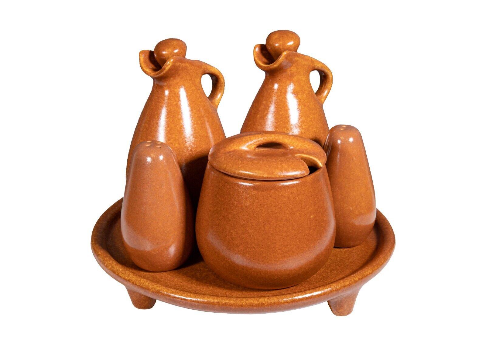 A 59 piece Ben Seibel Raymor Roseville matte terra cotta set. A massive set of Roseville Pottery. This gorgeous set of pottery designed by Ben Seibel for Roseville's Raymor collection. This set includes three sizes of plates, three sizes of bowls,
