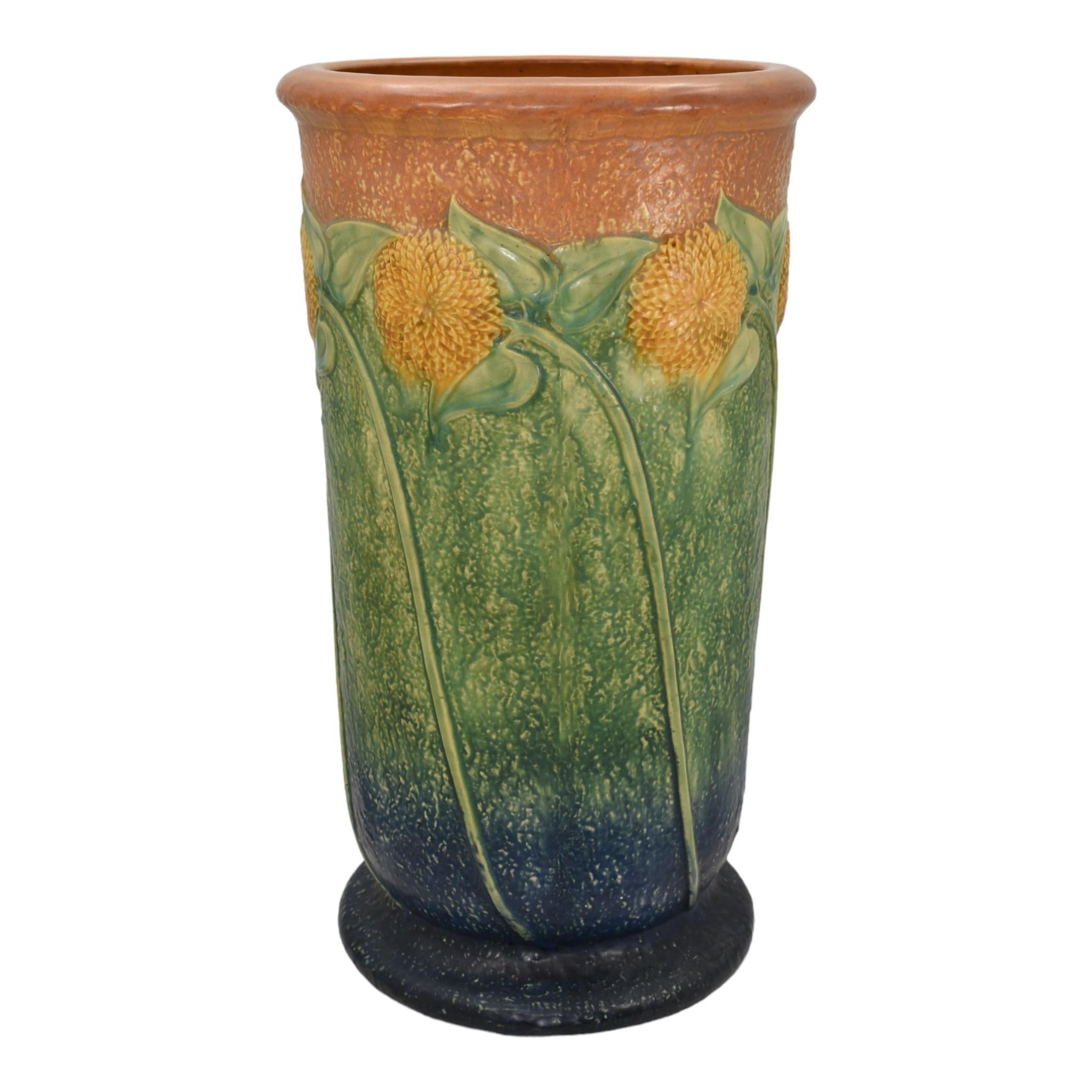 Roseville Sunflower 1930 Vintage Arts And Crafts Ceramic Umbrella Stand 770-20
Superior mold with great color. 
Excellent original condition. No chips, cracks, damage or repair of any kind. Minor factory glaze skip near the base. 
Bottom marked with