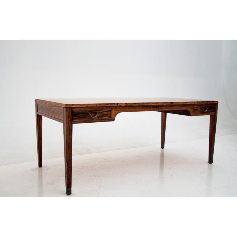 This coffee table comes from Denmark from the 1960s. Designed by Frits Henningsen. It has 4 drawers under the counter, 2 from each side. 
The furniture has been renovated, and it is maintained in very good condition.