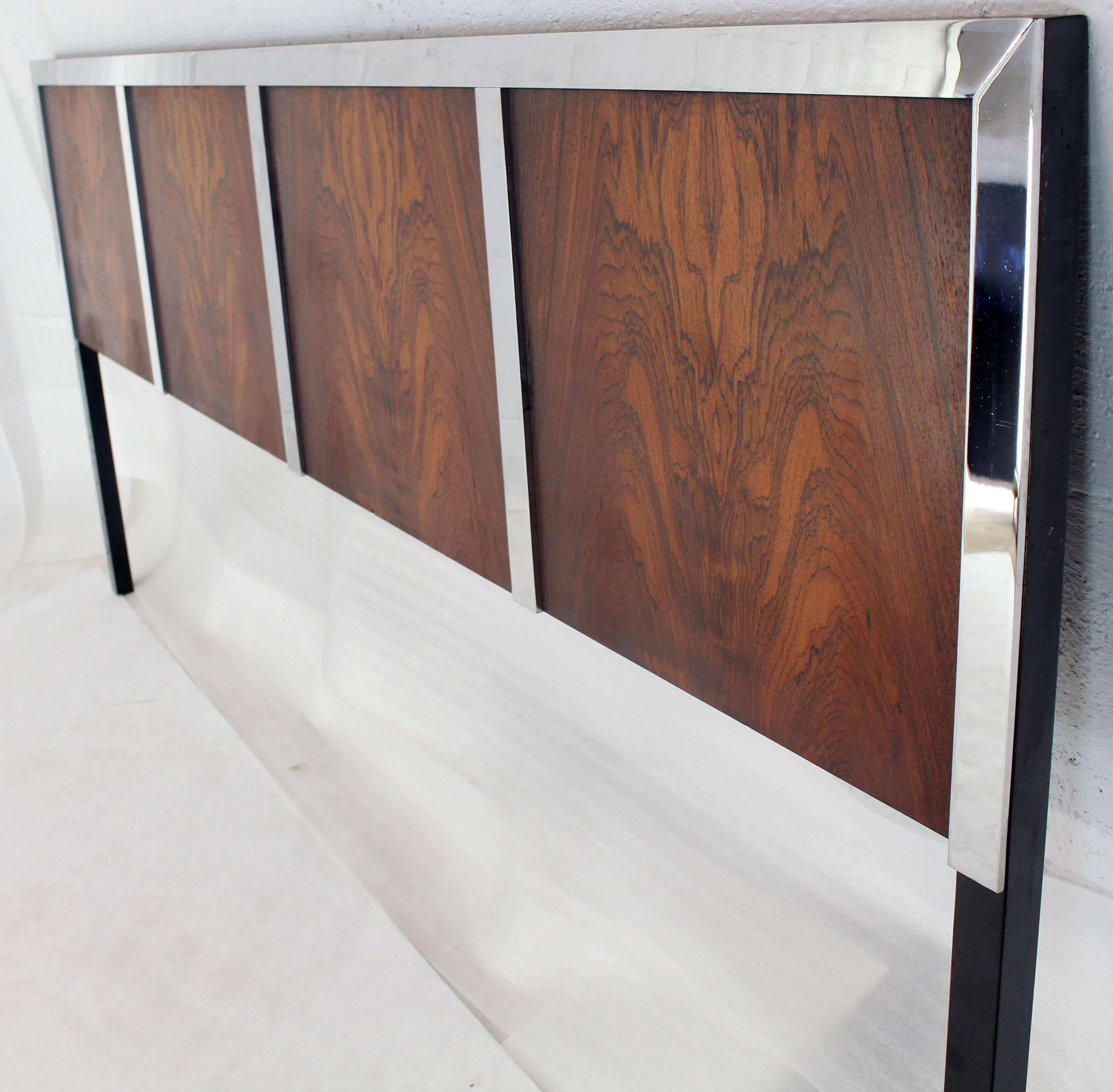 Heavy chrome border around flame pattern rosewood Mid-Century Modern king-size headboard bed.