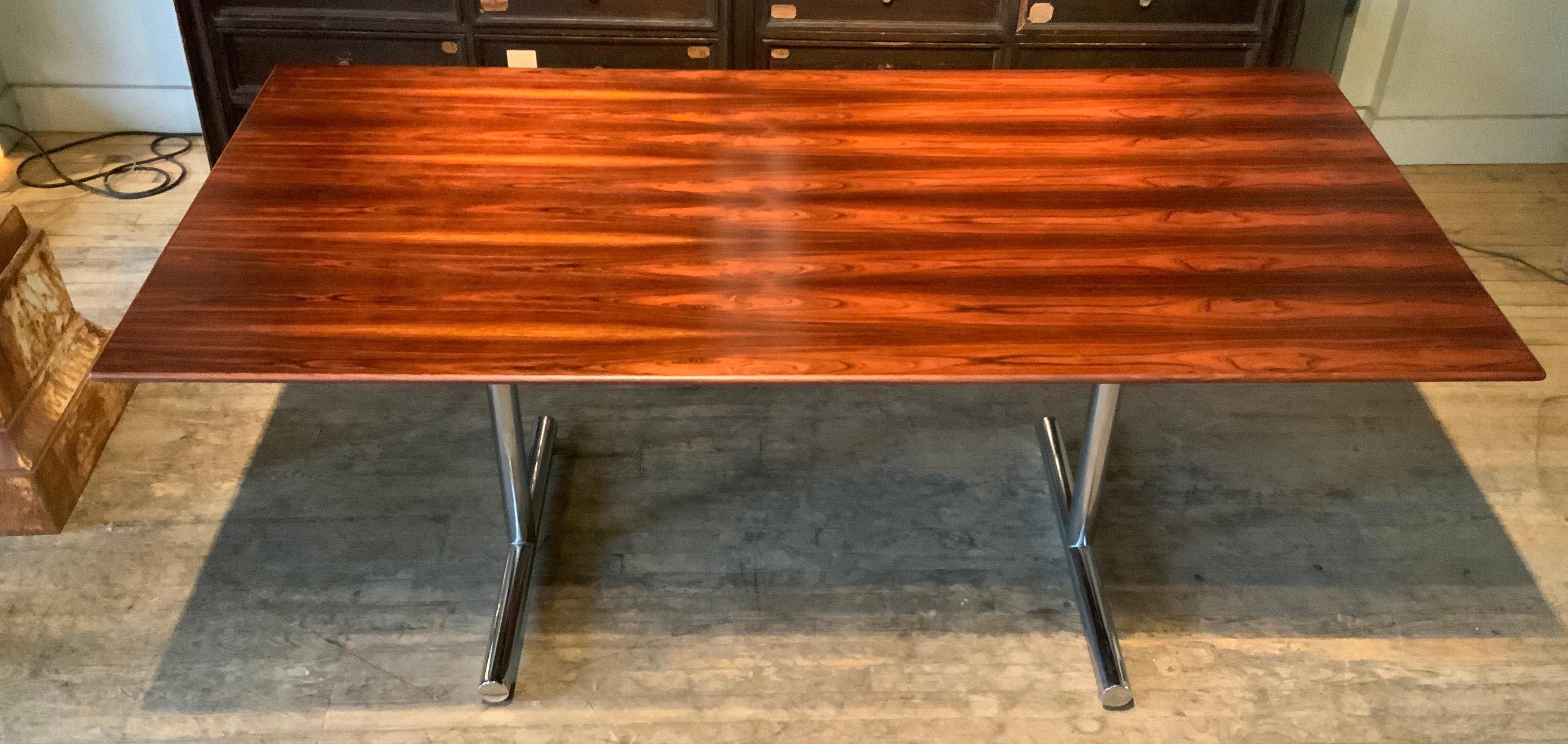 An incredible 1970s chrome base dining table or desk with a stunning brazilian rosewood top.

Amazing spare and beautiful design, perfect for a dining table or writing desk. the rosewood top is in beautiful condition, having just been