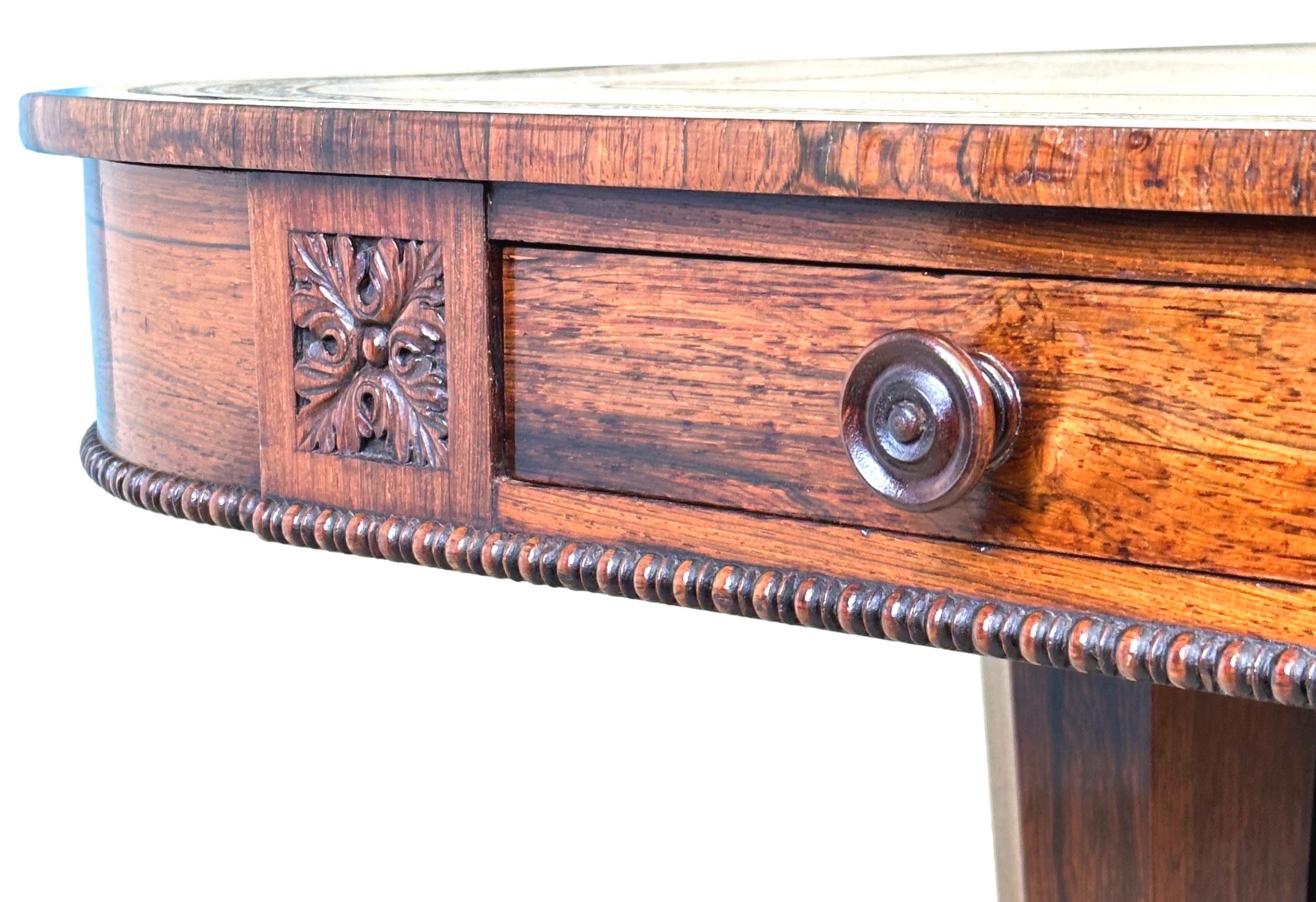 An exceptional quality mid-19th century, William IV Period, rosewood writing table having blind tooled leather inset to crossbanded top, over two drawers with original turned wooden knobs opposed by two false drawers, to extremely elegant shallow