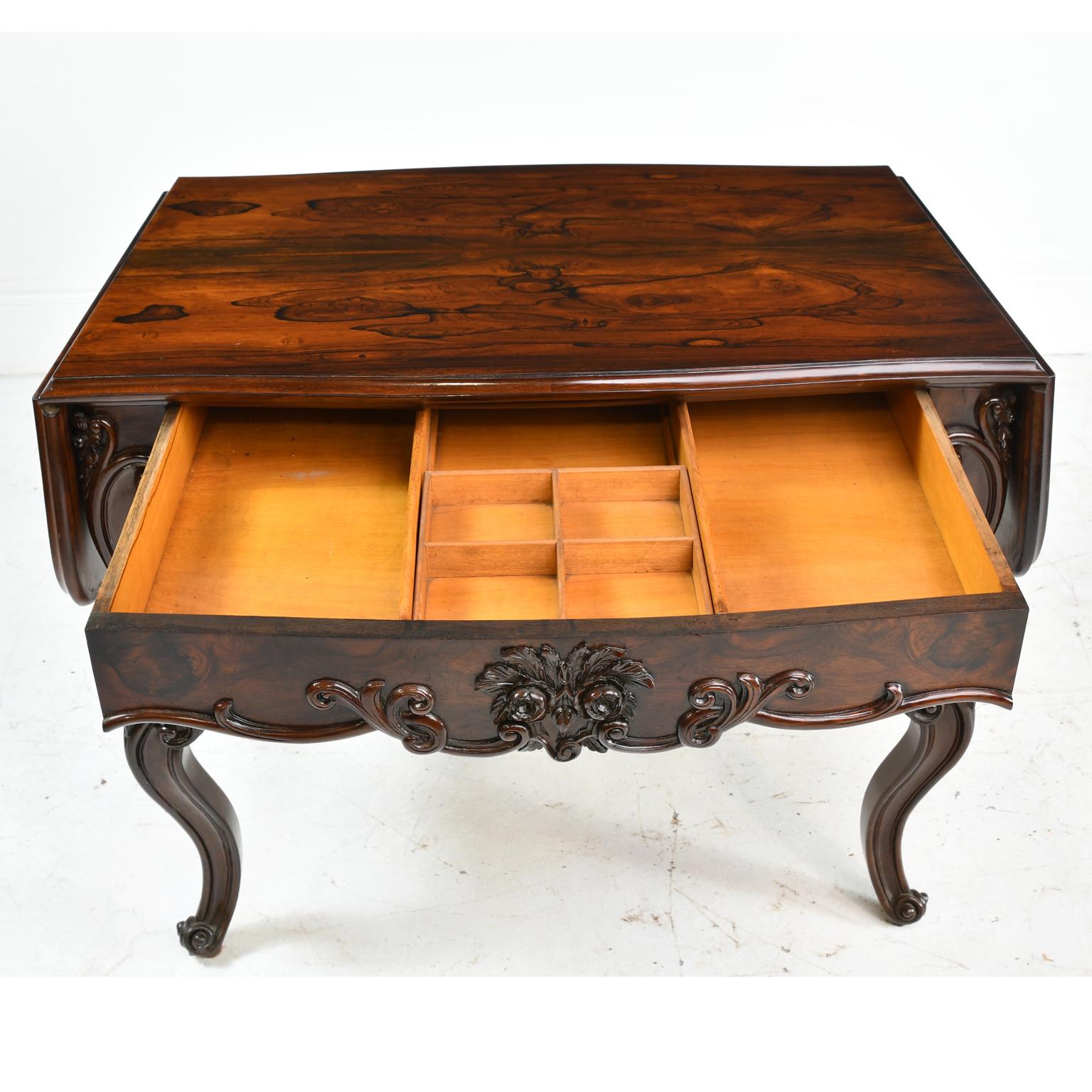 A beautiful American Rococo Revival sofa table in rosewood with shaped drop-leaves, escargot feet, and well-articulated foliate carvings on apron and cabriole legs. Attributable to well-known New York cabinetmaker, Joseph Meeks & Sons. This is a