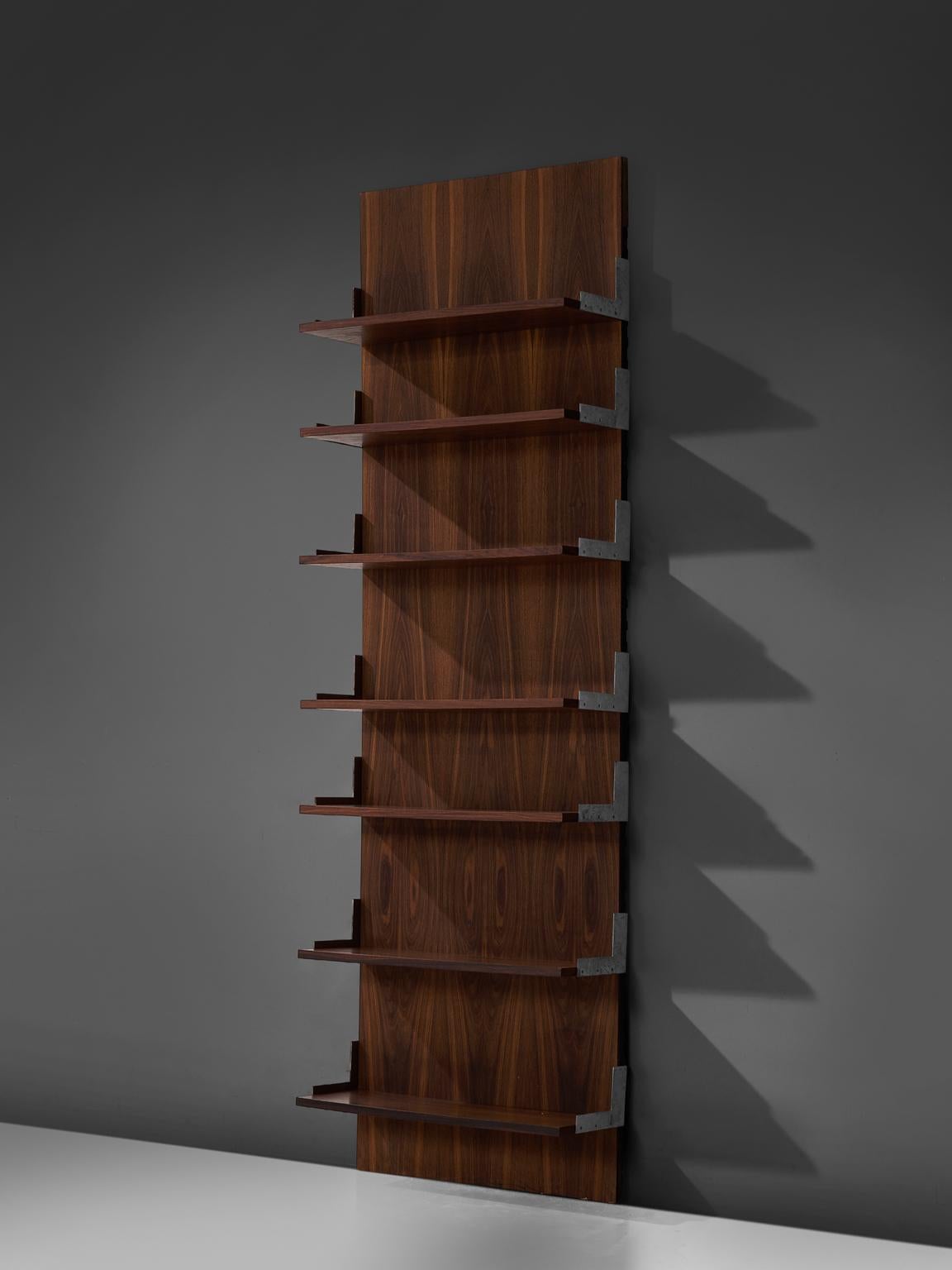 Bookcase or wall unit, aluminum and rosewood, Italy, 1950s.

This wall-mounted shelving unit is one section large. The order and lay out of this unit is adjustable and holds seven shelves. The shelves are mounted on steel corners. The pieces holds