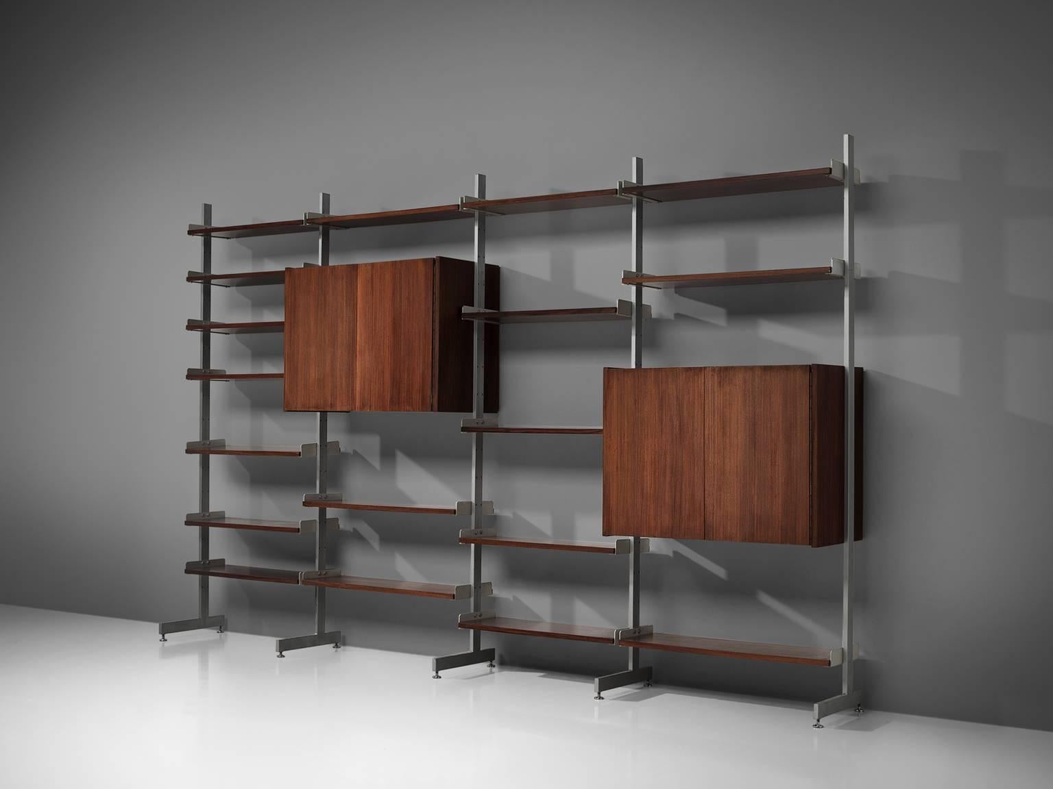 Bookcase or wall unit, aluminum and rosewood, Scandinavia, 1950s.

This wall-mounted shelving unit is four sections large. The order and lay out of this unit is adjustable and can be placed according to your own taste or style. The shelves are