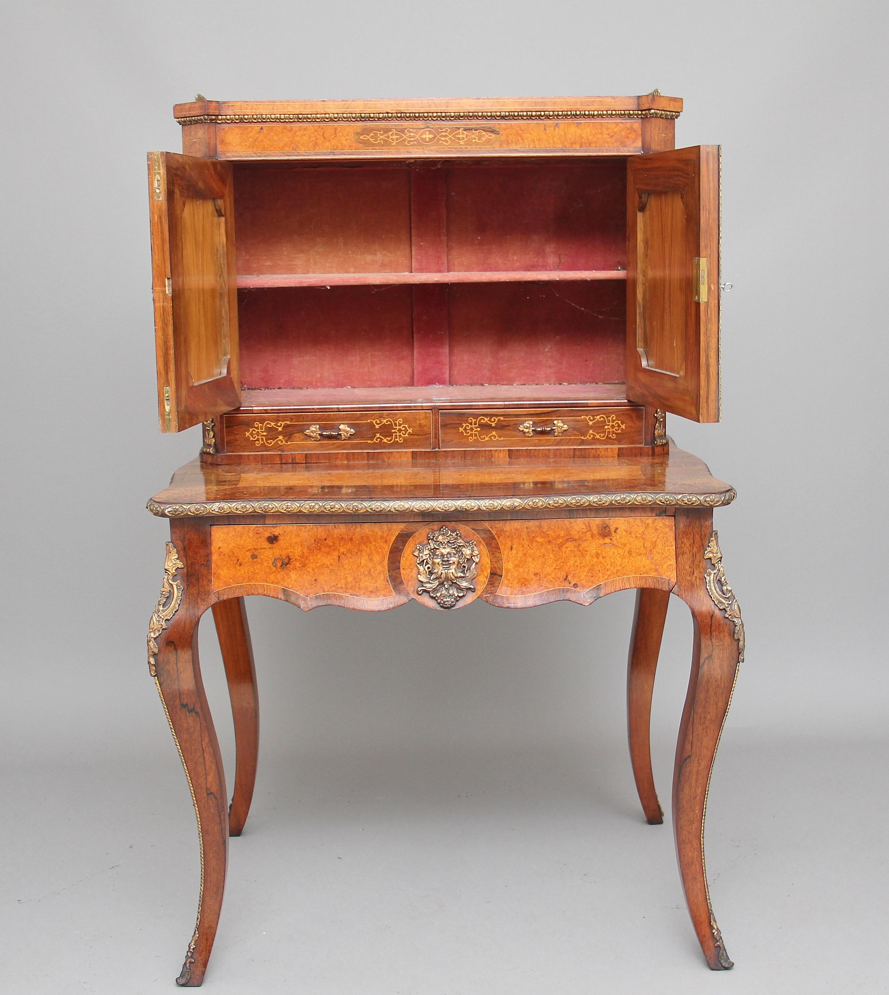 A superb quality, 19th century rosewood and amboyna bonheur du jour, the canted top section having a brass gallery with two panel doors below opening to reveal a single fixed shelf inside and two small drawers below the doors, lovely quality ormolu