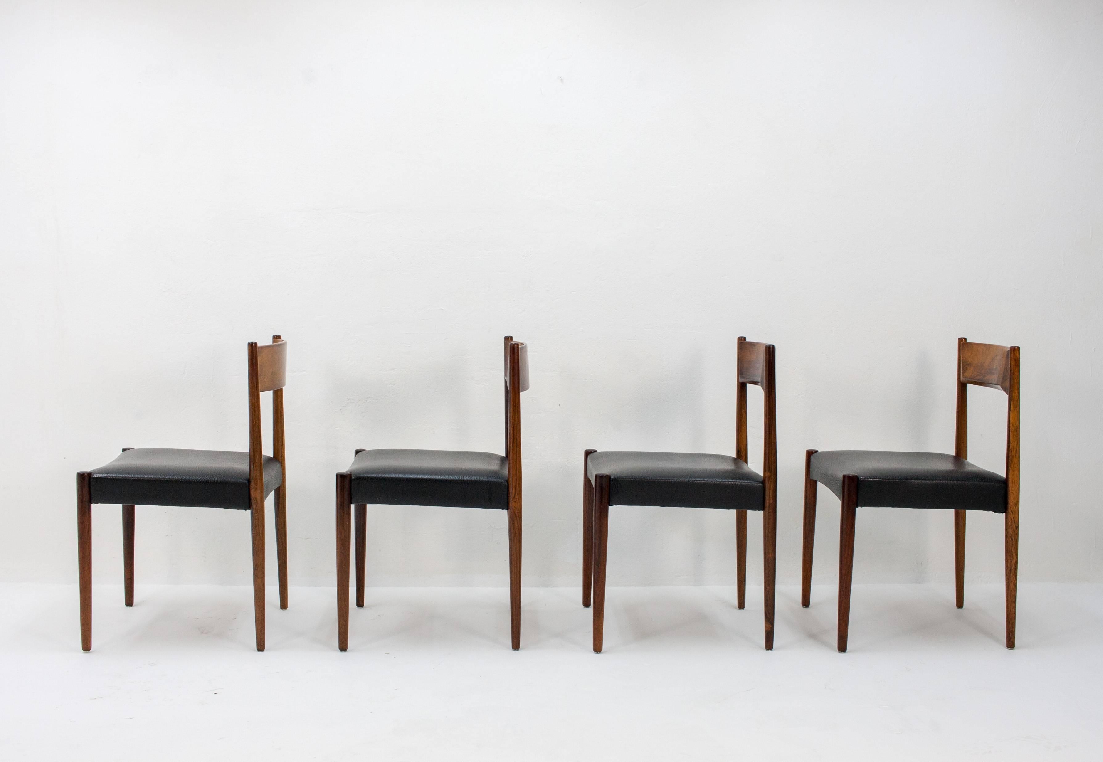 Set of four stylish dining chairs by Lübke. Solid rosewood frames with leather upholstery, 1960s. These chairs are in truly excellent condition.
