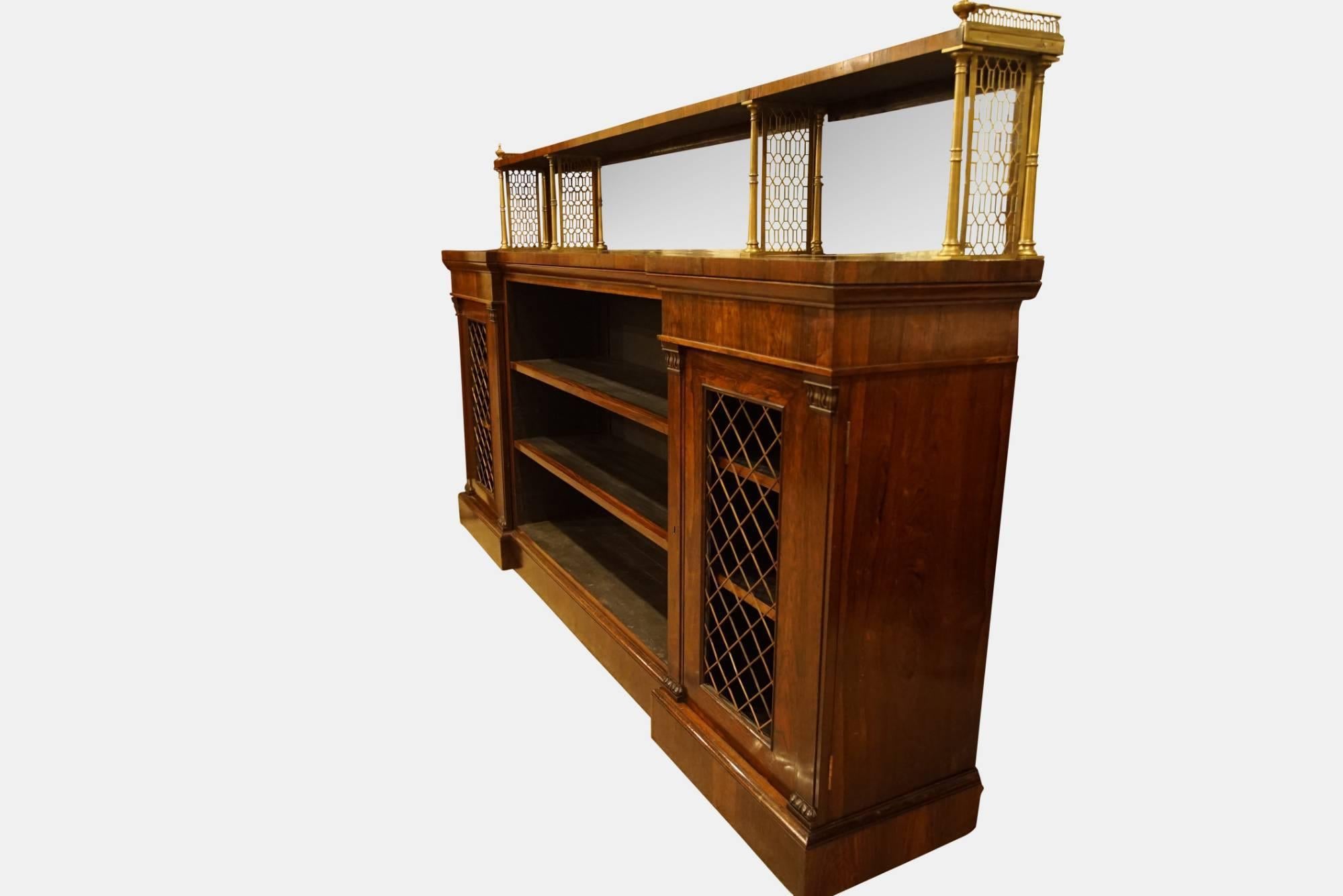 Regency rosewood and brass open bookcase with brass grills in end doors,

circa 1815.