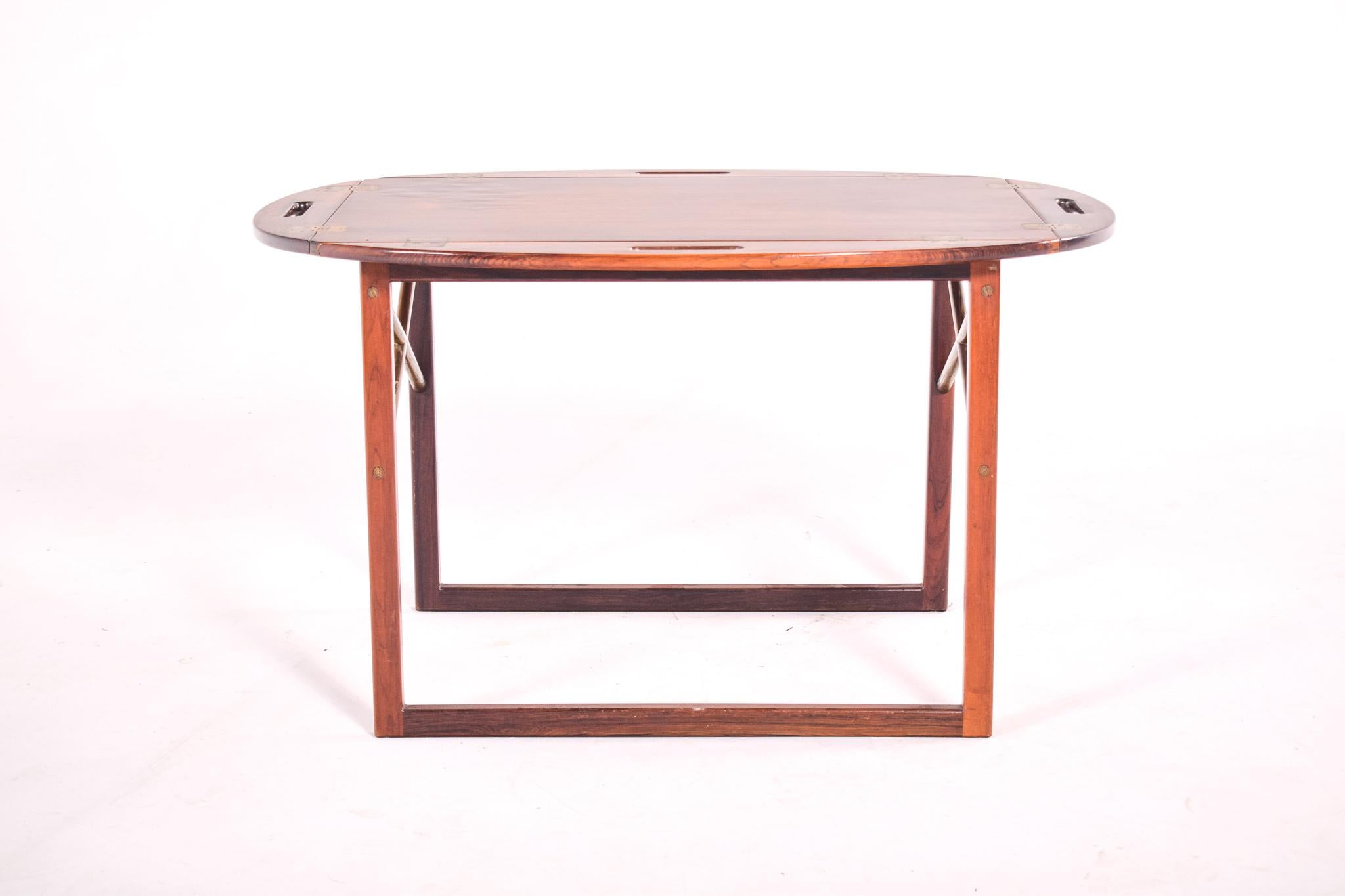 Excellent tray table in rosewood with brass cross stretchers. Danish modern design by Svend Langkilde for Illums Bolighus. removable and hinged top.