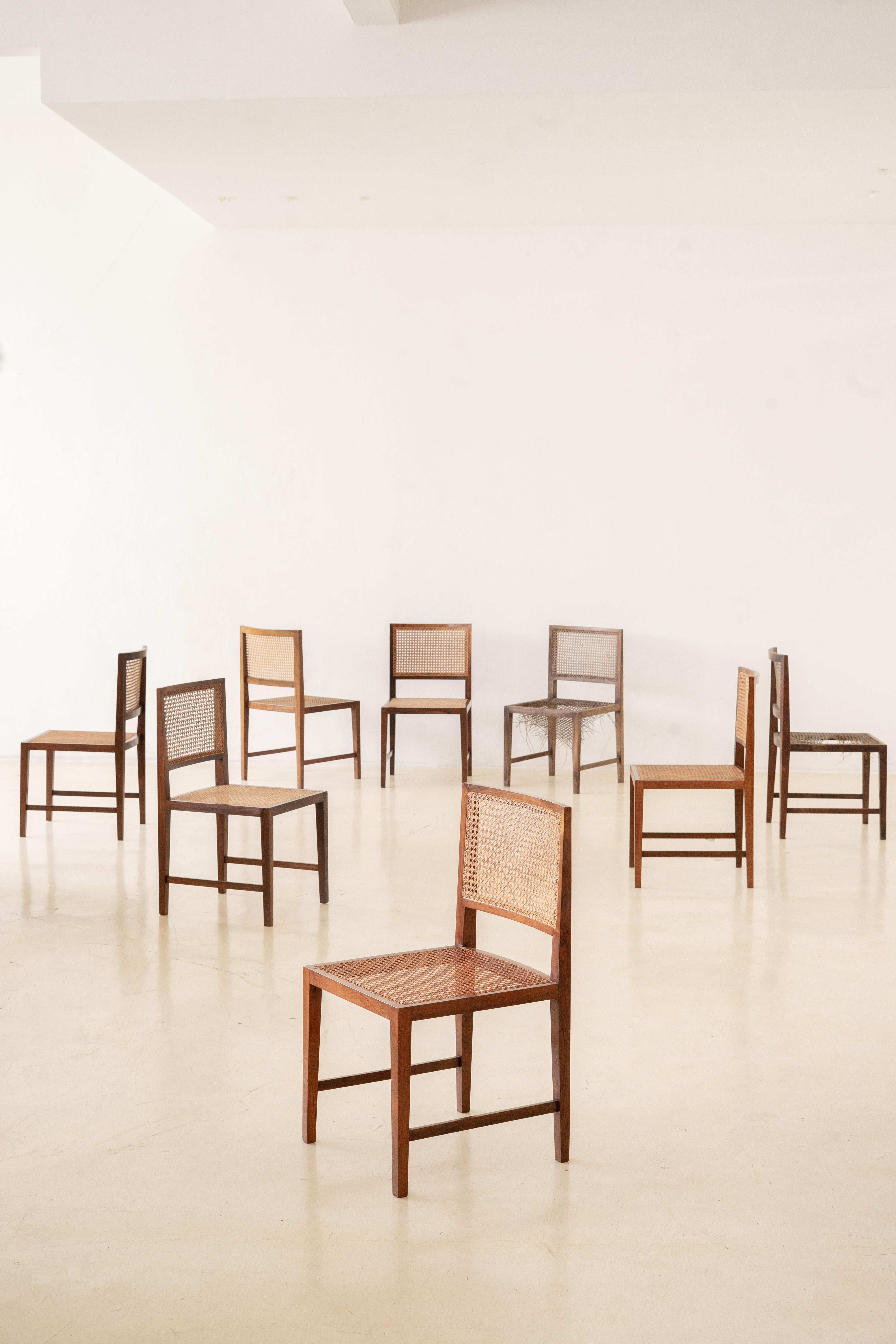 ML Magalhães produced this set of eight dining chairs in the 1960s. The pieces have solid Rosewood structure and seats and backrests in natural plaited cane. 

With rectangular forms and corners in almost all the structure, one beautiful detail to