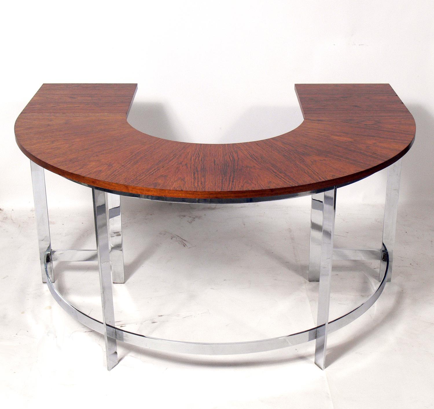 Rosewood and chrome arc desk and chair, circa 1960s. Very heavy and well made. The chair is currently being reupholstered and can be completed in your fabric at no additional charge. Simply send us two yards of your fabric after purchase. With the