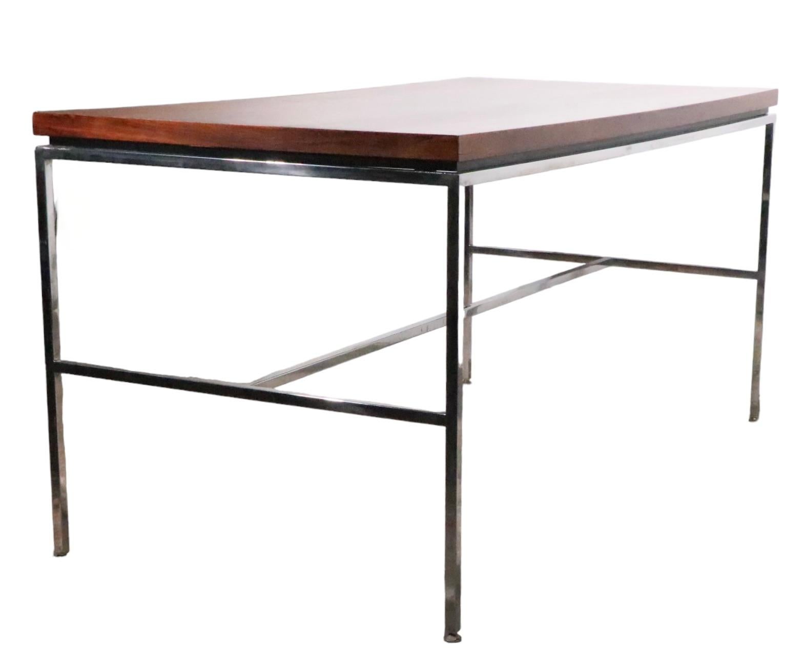 Stunning midcentury, Hollywood Regency, Post Modern design writing table, desk, made by Drexel as part of their Index series, possibly designed by Milo Baughman, circa 1960/1970s.
The desk features a rectangular rosewood top, on an architectural