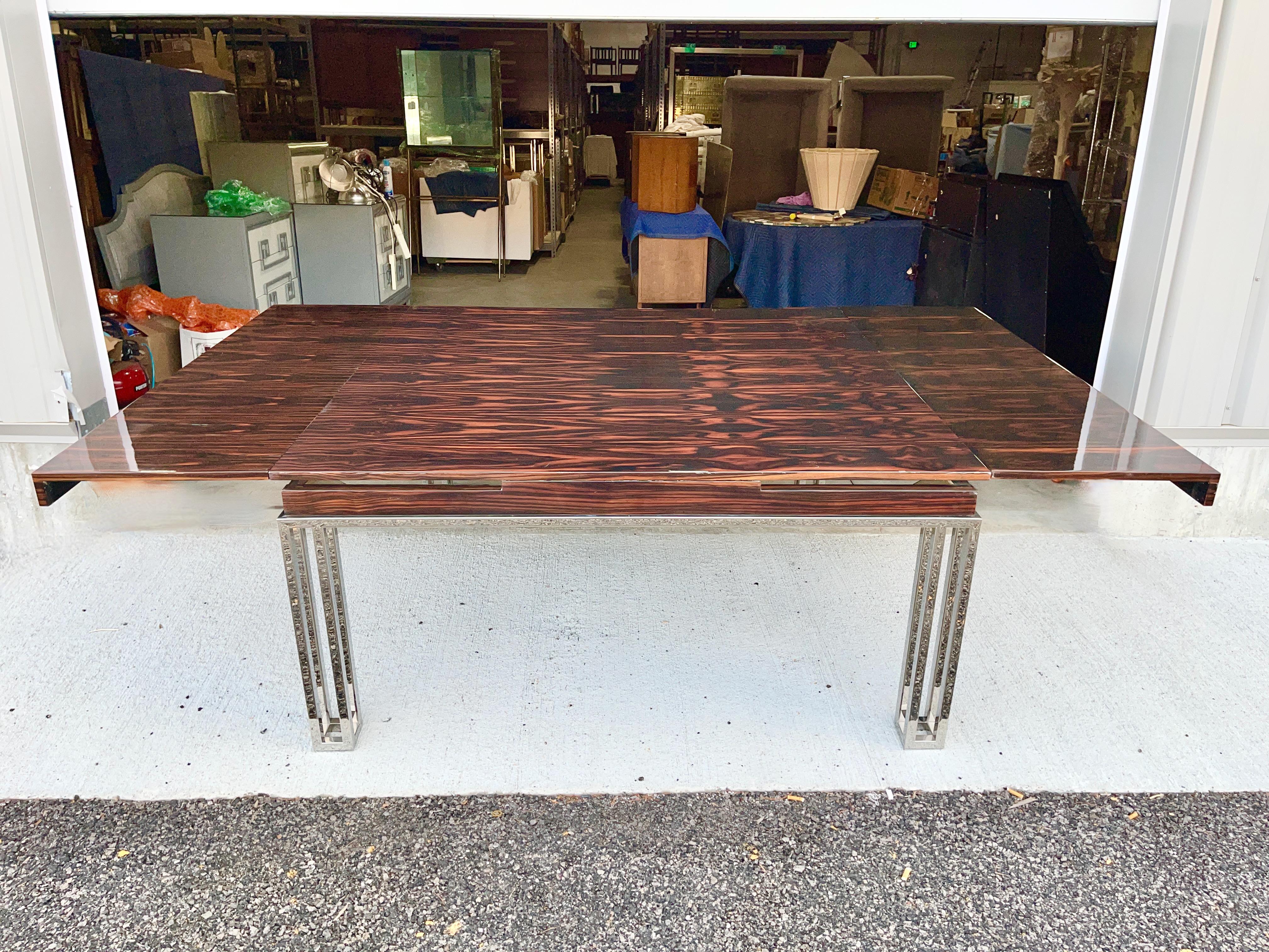 Custom extending dining table with polished chrome geometric base and highly figured rosewood top finished in clear high gloss polyester.
30 inches high by 63 inches wide by 63 inches deep. 
Can be extended an additional 36 inches by pulling out
