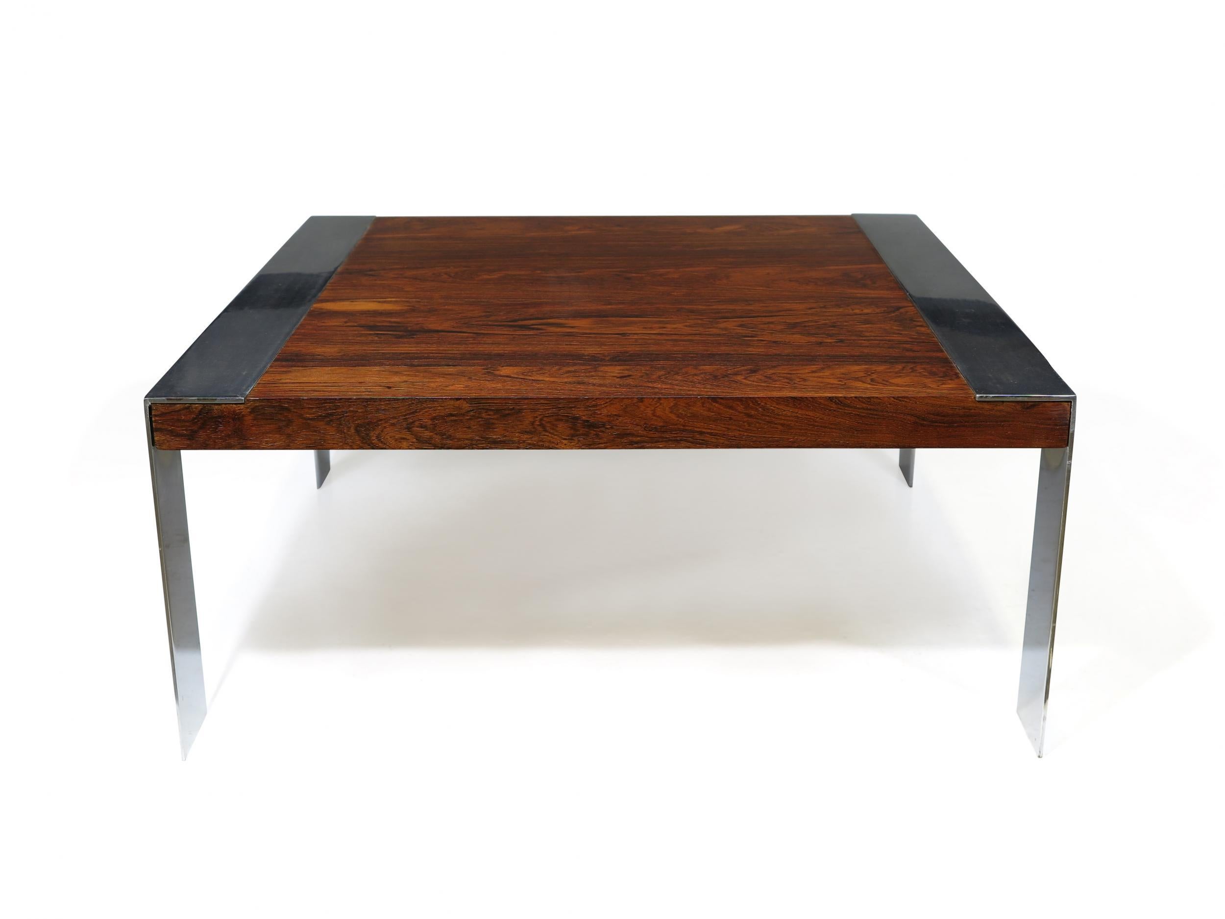 Midcentury rosewood coffee table with book-matched rosewood on heavy chrome legs. Chrome shows light wear and can be re-chromed upon request.