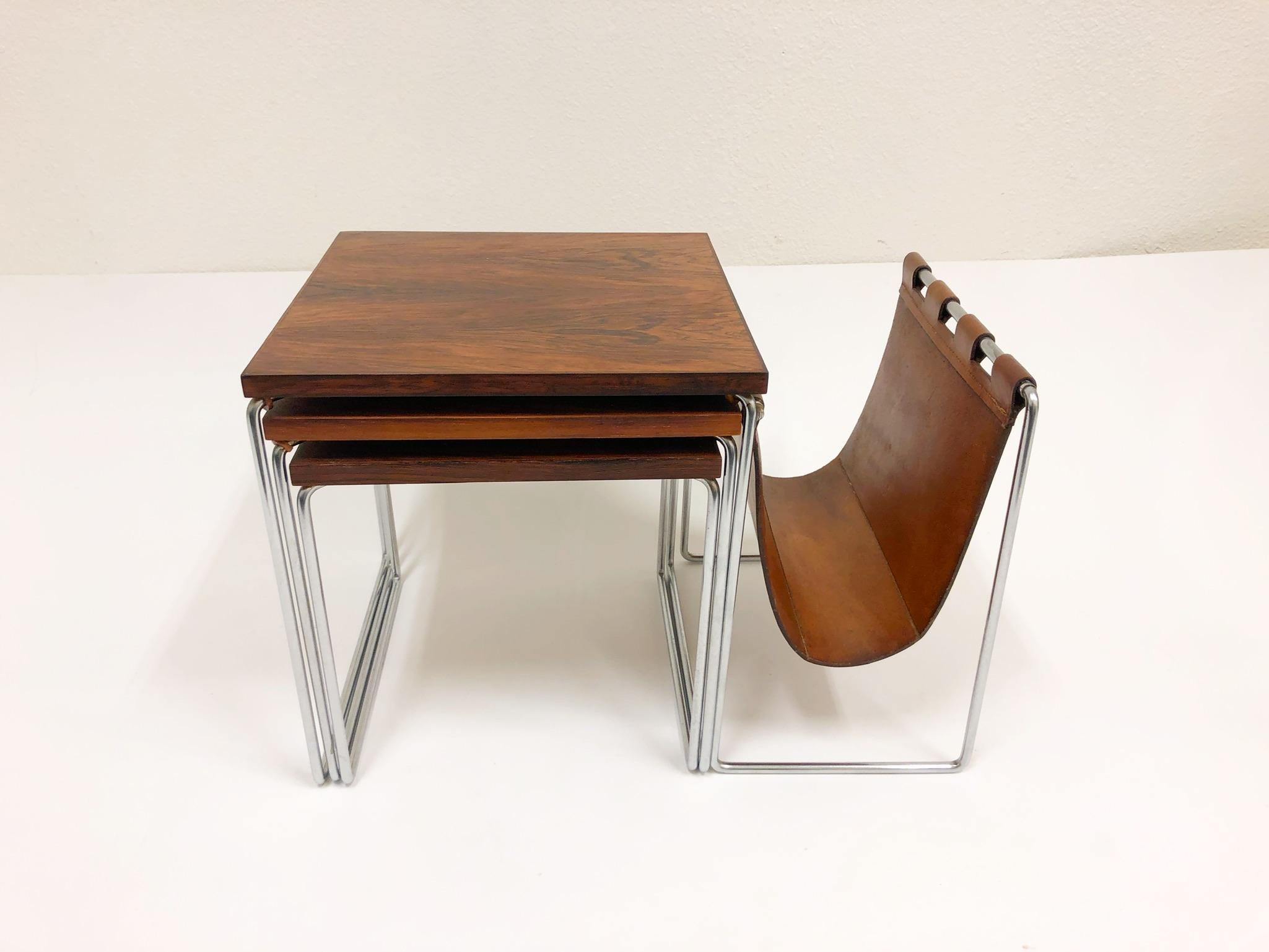 A beautiful set of three rosewood and chrome with a saddle leather magazine holder. This are in beautiful original condition.
Dimensions: Large -22” wide 13.75” deep 14.5” high.
Middle -12.75” wide 12.75” deep 13.25” high.
Small -11.75” wide