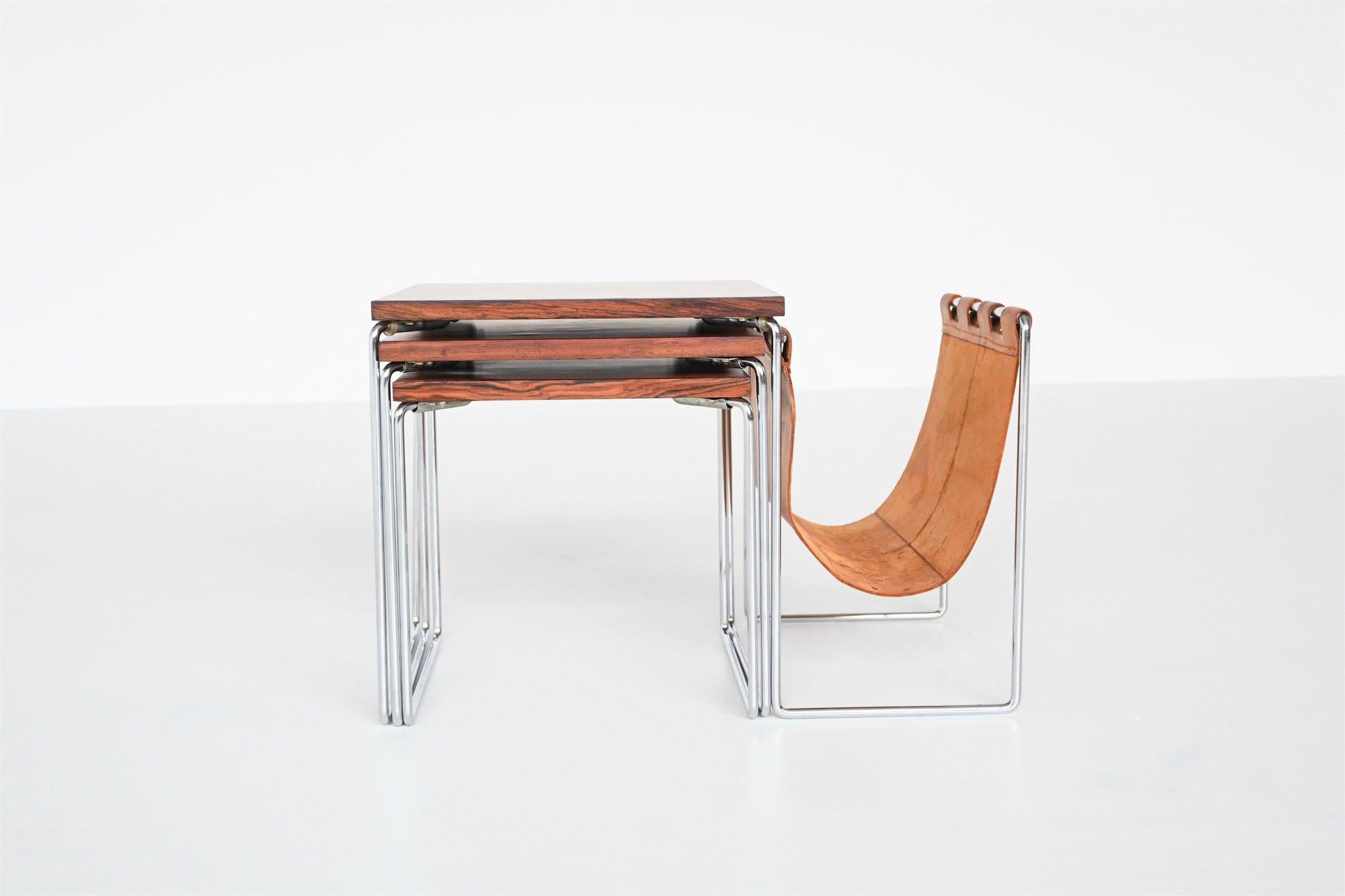 Beautiful set of three nesting tables by unknown designer or manufacturer, The Netherlands 1960. These tables have a chrome plated solid metal sled frame, nicely grained rosewood veneered top and a patinated natural saddle leather magazine basket.