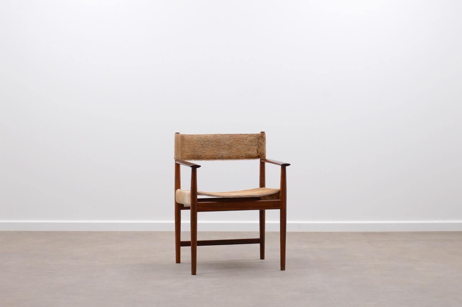Rosewood and cow hide chair by Kurt Østervig for Sibast, 60s Denmark. Solid Rosewood frame and cow hide leather. Cow hide is reupholstered and a unique combination. The armrests are refinished. Signed with Sibast logo. In very good vintage