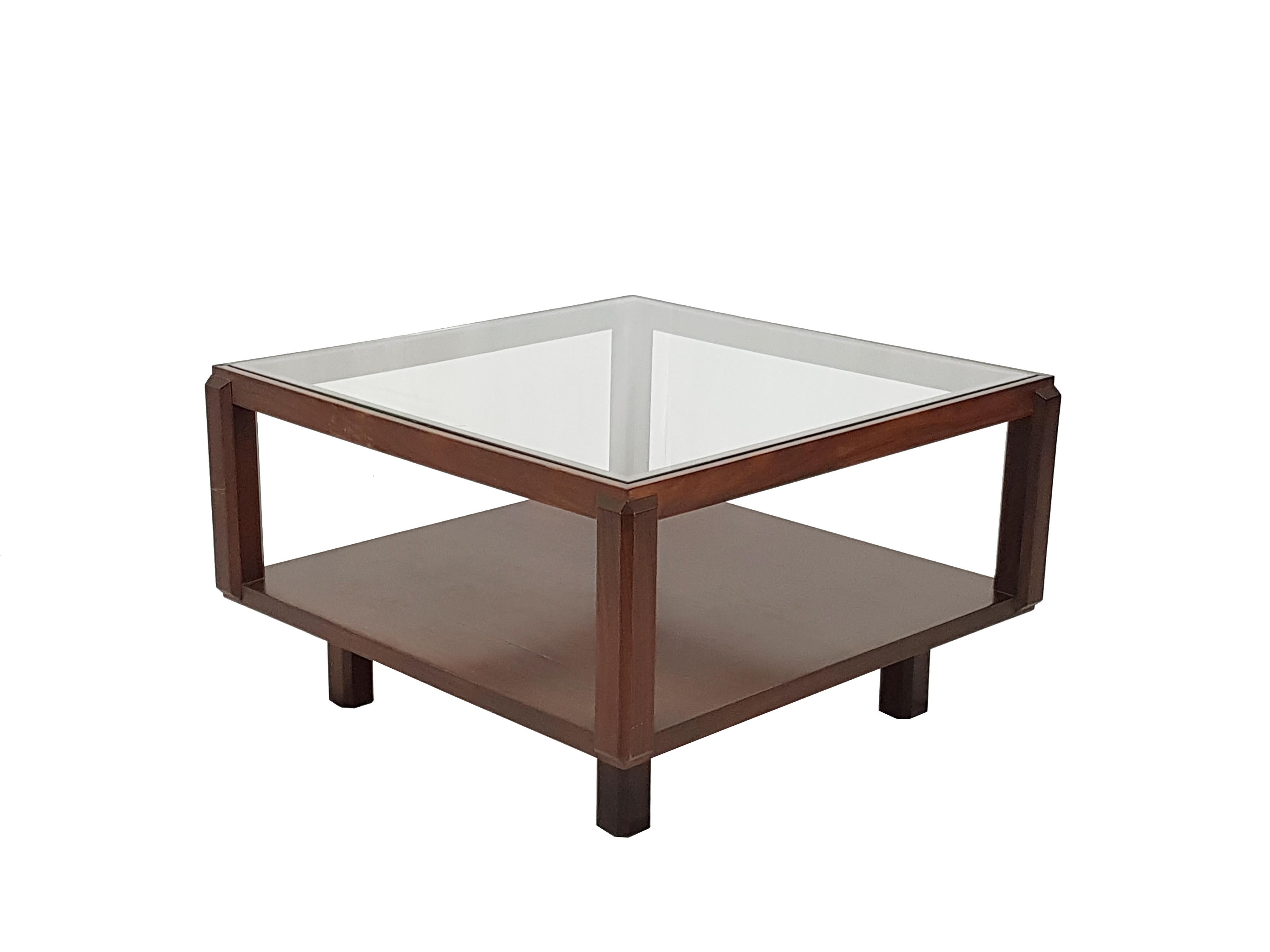 This coffee table was made from a rosewood faceted structure with a glass top.
It remains in good condition: a small chipping on one corner of the glass top as showed in picture. Two light scratched on the wooden frame.